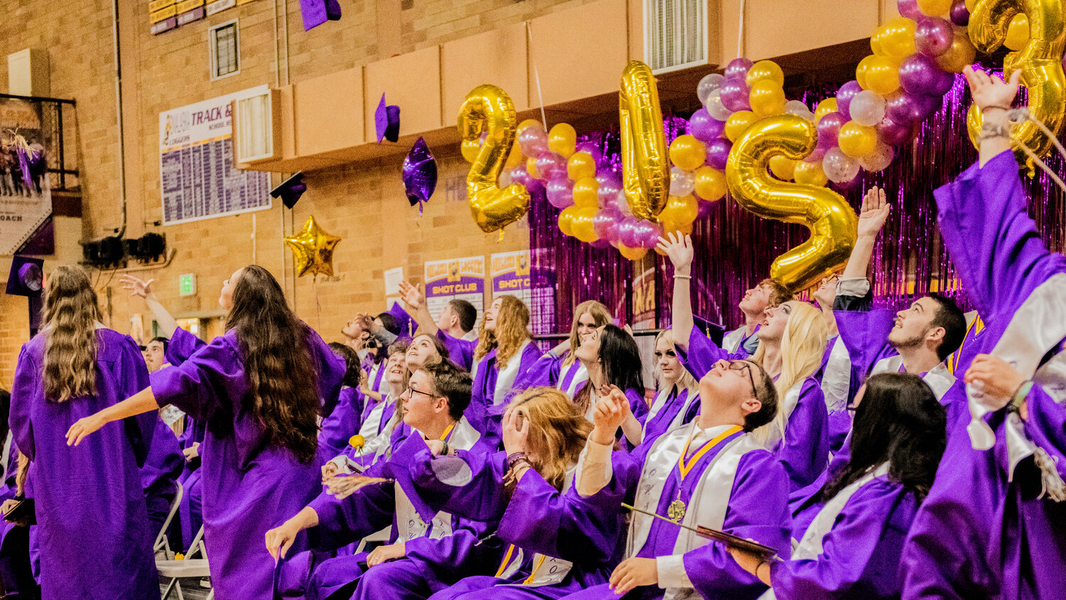 Onalaska High School’s 100th graduating class of seniors throws their caps after turning the tassels to officially mark their graduation on Friday, June 9.