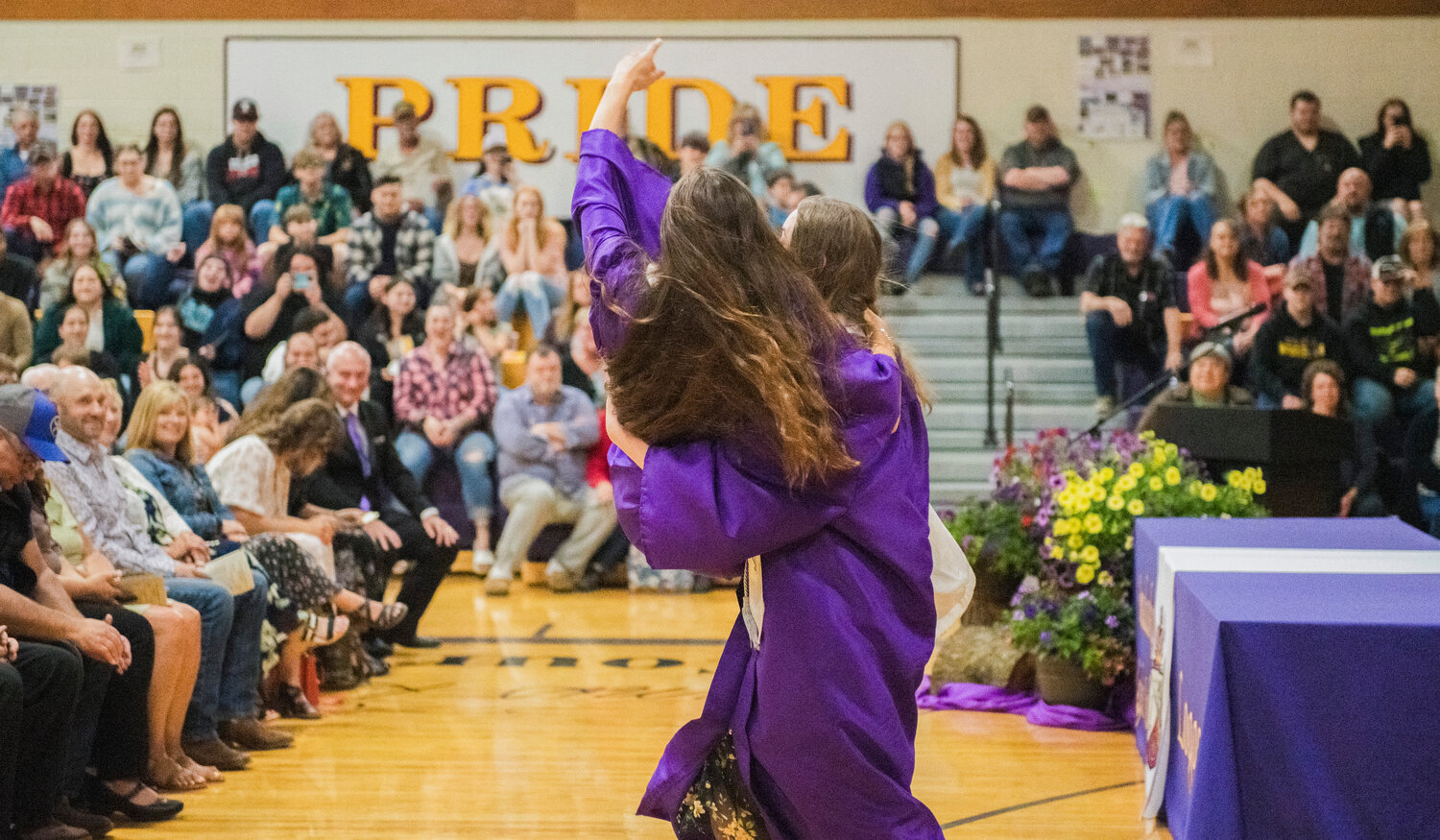 Onalaska High School Class of 2023 Valedictorian Brooklyn  Sandridge is carried out of the gym by Salutatorian Austyn Nelson after turning their tassels on Friday.