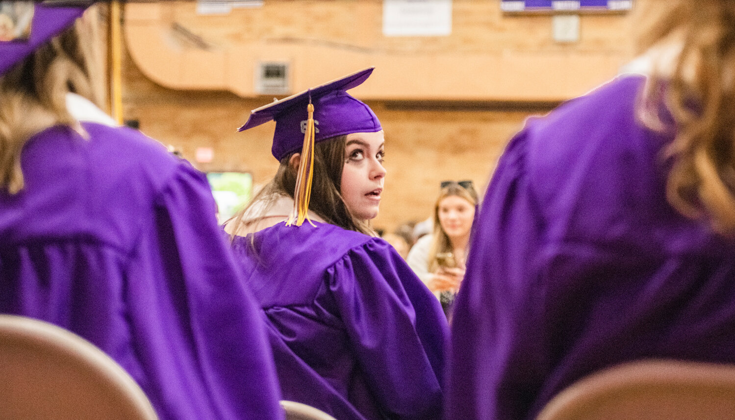 Onalaska High School Class of 2023 speaker Molly White looks toward classmates as parents and friends photograph soon-to-be graduates on Friday, June 9.