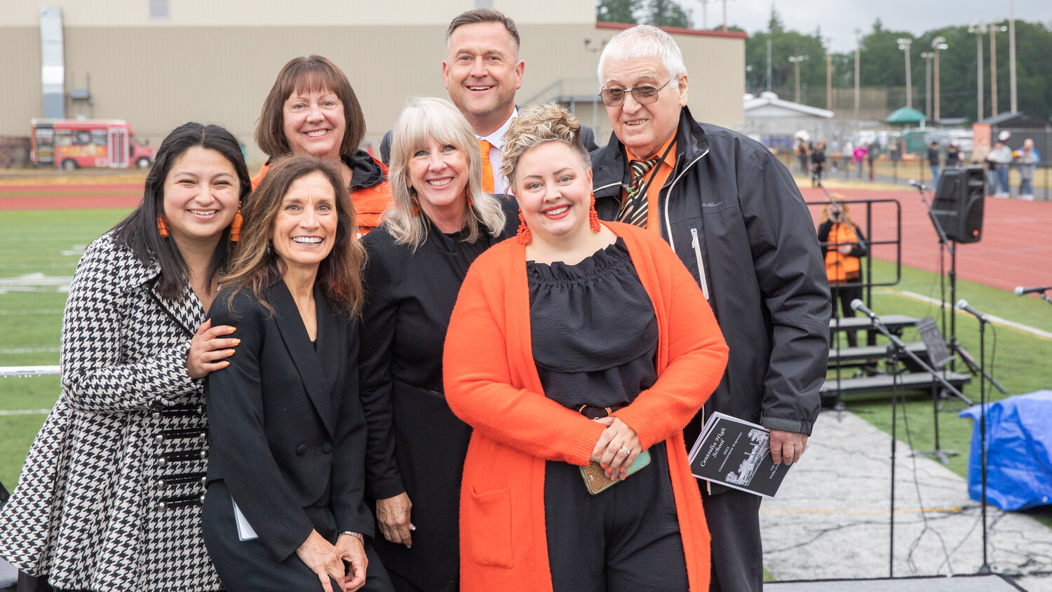 From left, Maritza Bravo, Superintendent Lisa Grant, Deb Parnham, Vickie Jackson, Centralia High School Principal Scot Embrey, Board Vice President Mandi McDougall and Board President Tim Browning pose for a photo during a graduation ceremony in June 2023 at Tiger Stadium.