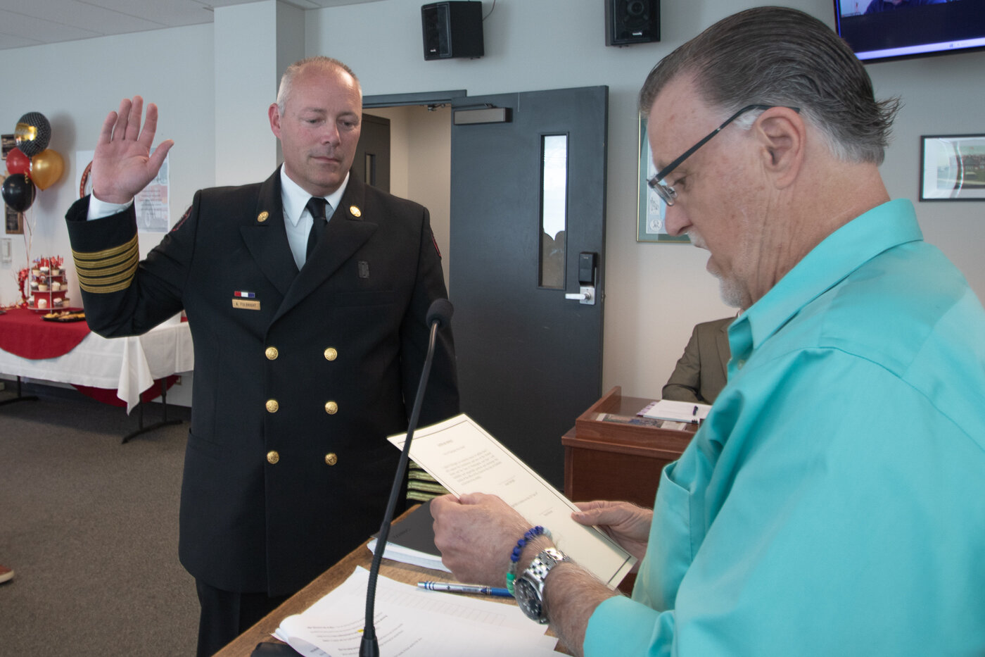 Chehalis Mayor Tony Ketchum swears in the city's new fire chief Adam Fulbright at the beginning of a city council meeting earlier this month.