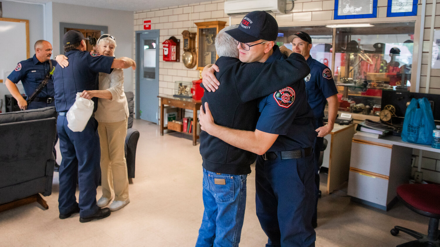 Darren Banks, the lead medic on an April call to save the life of Scott Olson, 67, hugs Olson after describing how a defibrillator was used 11 times before Olson’s heart was stabilized. The reunion occurred Wednesday morning at the Riverside Fire Station along North Pearl Street in Centralia.
