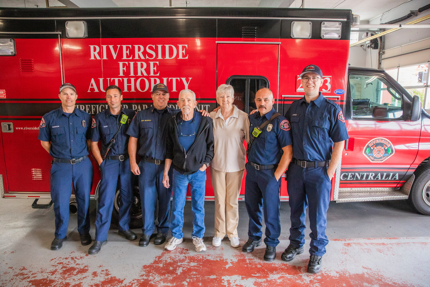 Scott Olson, 67, of Centralia, and his sister, Robyn, smile for a photo with Riverside firefighters from left, Randy Rossow, Shay Goff, Captain Casey McCarthy, Jade Gross and Darren Banks at the Riverside Fire Station along North Pearl Street on Wednesday, July 12. Olson went to the station to thank EMTs and firefighter crews from Riverside Fire Authority who assisted an American Medical Response unit responding using a defibrillator and CPR machine to stabilize Olson’s heart April 7, 2023.