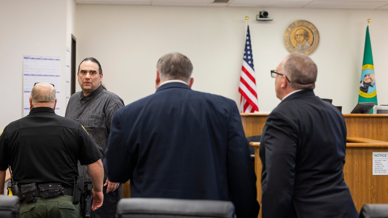 Two Dogs Salvatore Fasaga talks to his defense attorneys in Lewis County Superior Court after a verdict was reached during a bench trial in Chehalis on Friday, July 28.