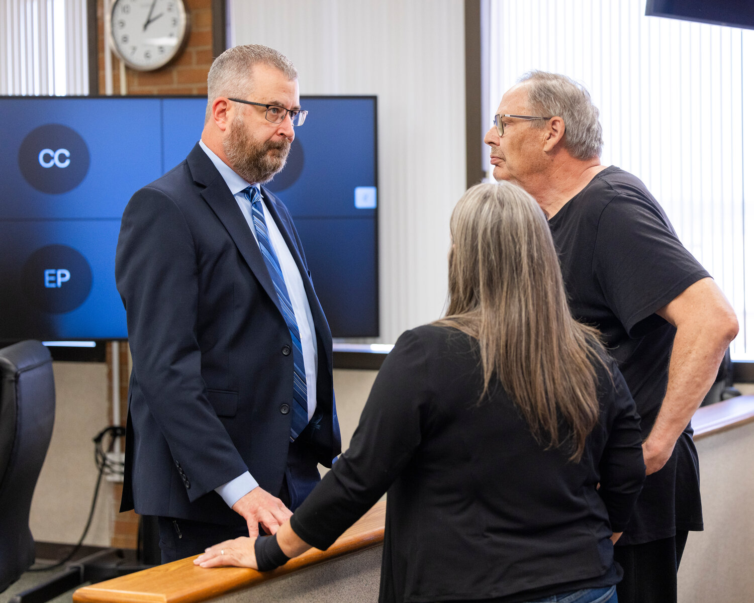 Prosecutors react and talk to attendees about a verdict in Lewis County Superior Court following a bench trial in Chehalis on Friday, July 28.
