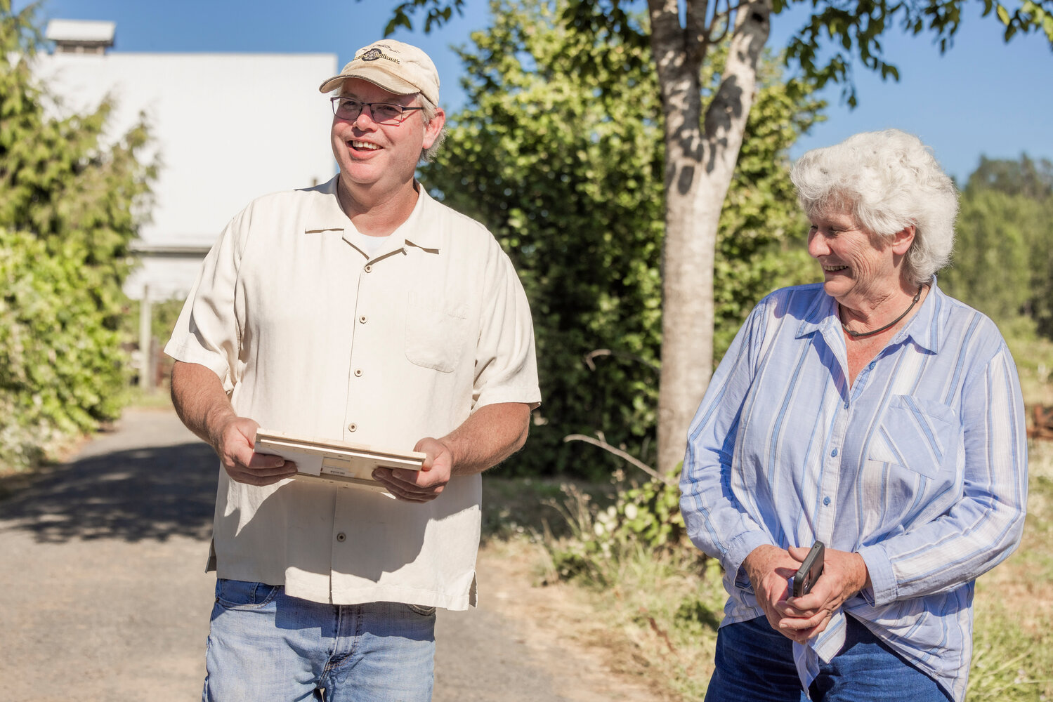 Dan Maughn smiles while talking about beekeeping after receiving a gift from Lewis County Farm Bureau President Maureen Harckom during a tour on Monday, July 31.