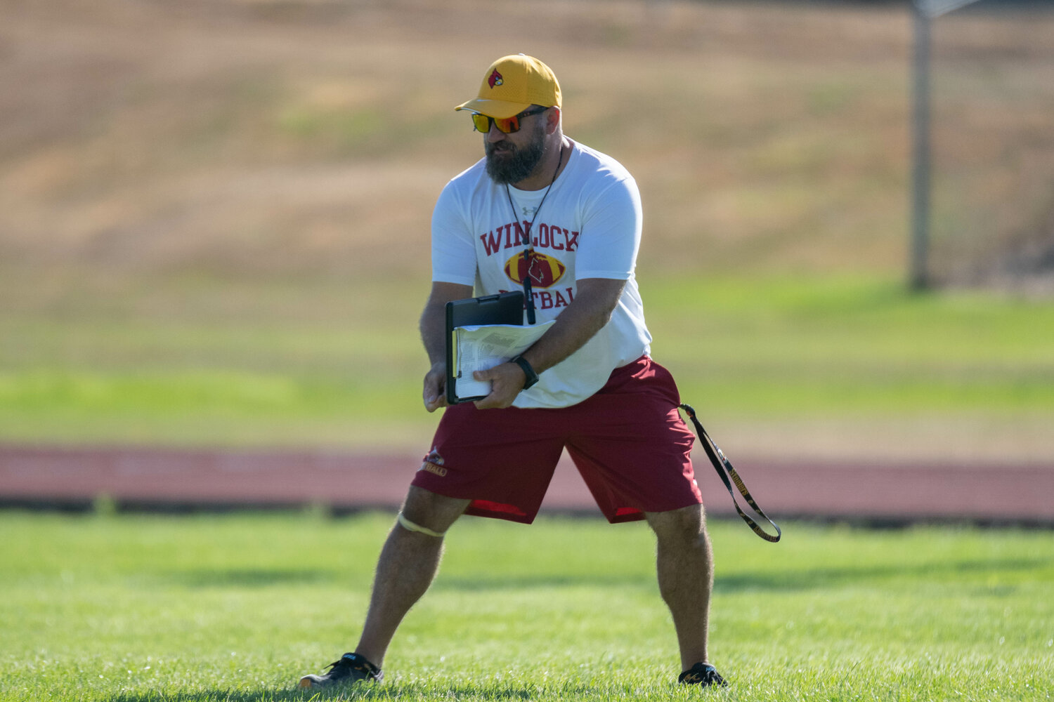 Winlock coach Ernie Samples demonstrates how he wants his quarterback to toss the football at the Cardinals' practice on Aug. 19.