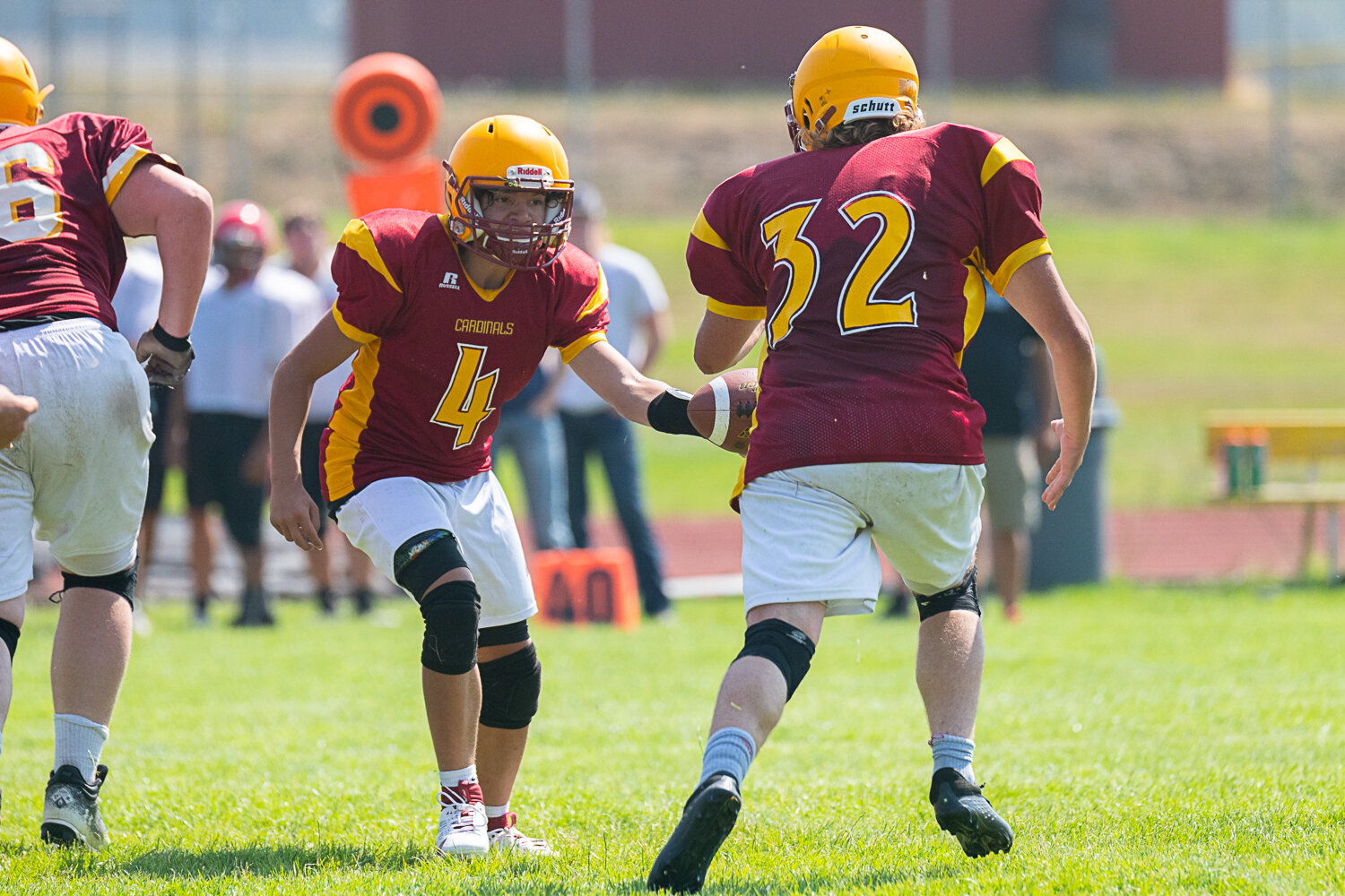 Landen Cline hands the ball off to James Cusson at Winlock's 8-man jamboree on Aug. 26.