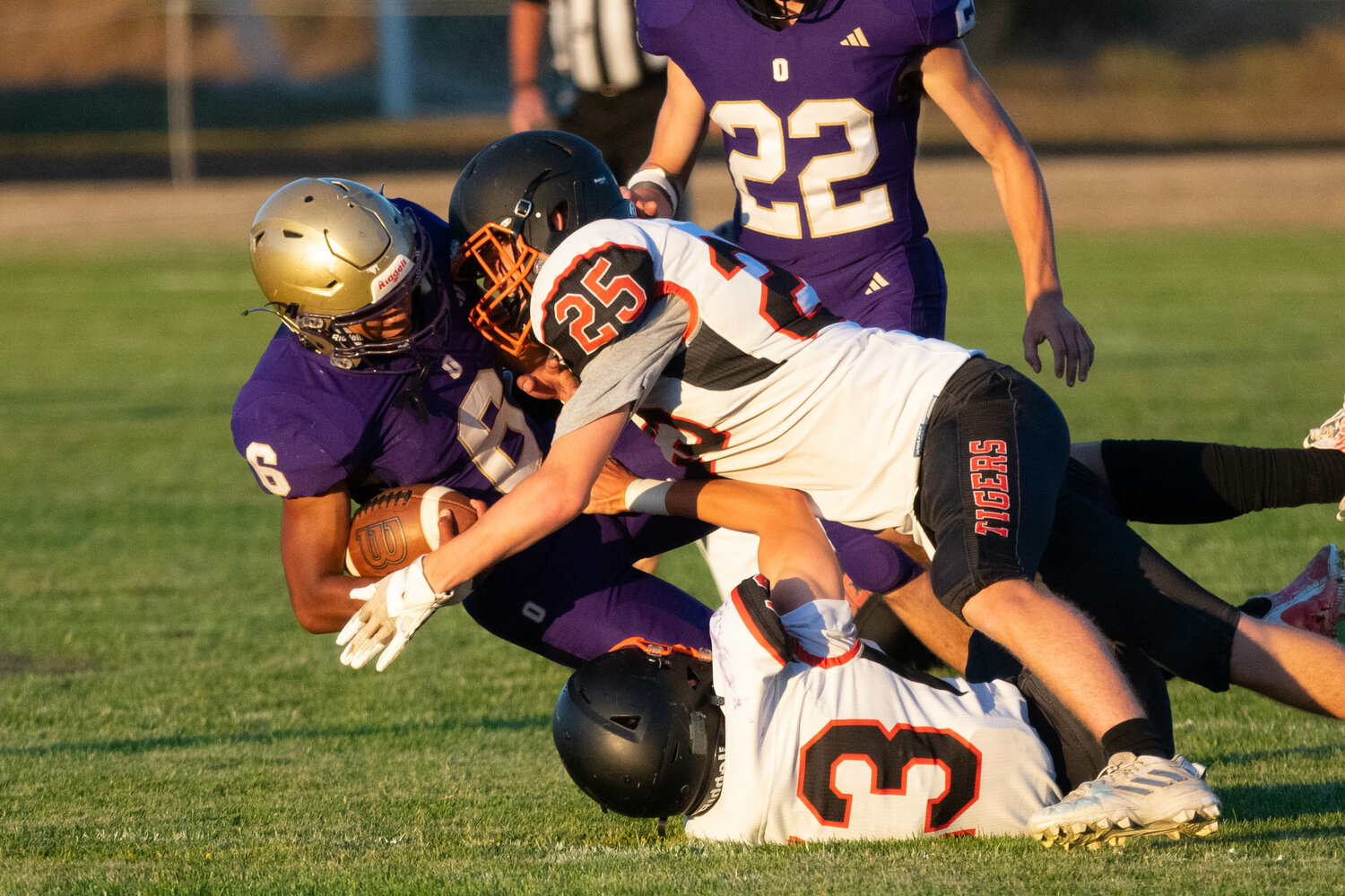 Napavine's Tyler Watson lays a  hit on Onalaska's Rodrigo Rodriguez during the first quarter of the Tigers' game against the Loggers on Sept. 8.