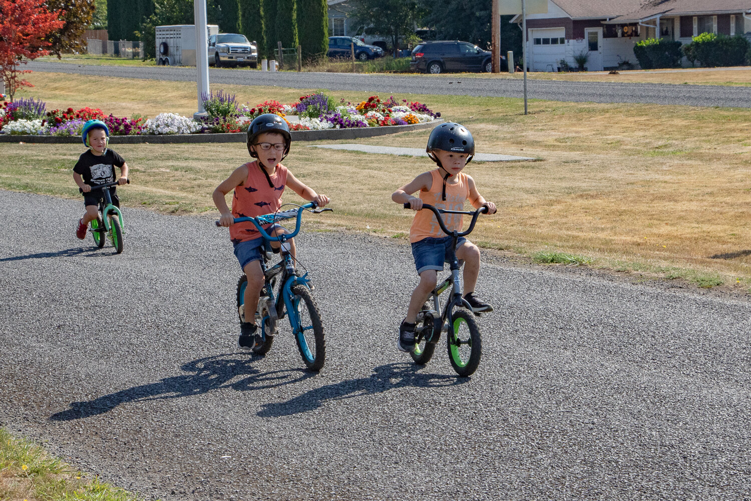 Brothers Leon, right, and Talon Huang race down West Main Street with Jack Wyman racing behind them in Mossyrock during the children's bike races kicking off Mossyrock's Mexican Independence Day celebration on Saturday, Sept. 16.