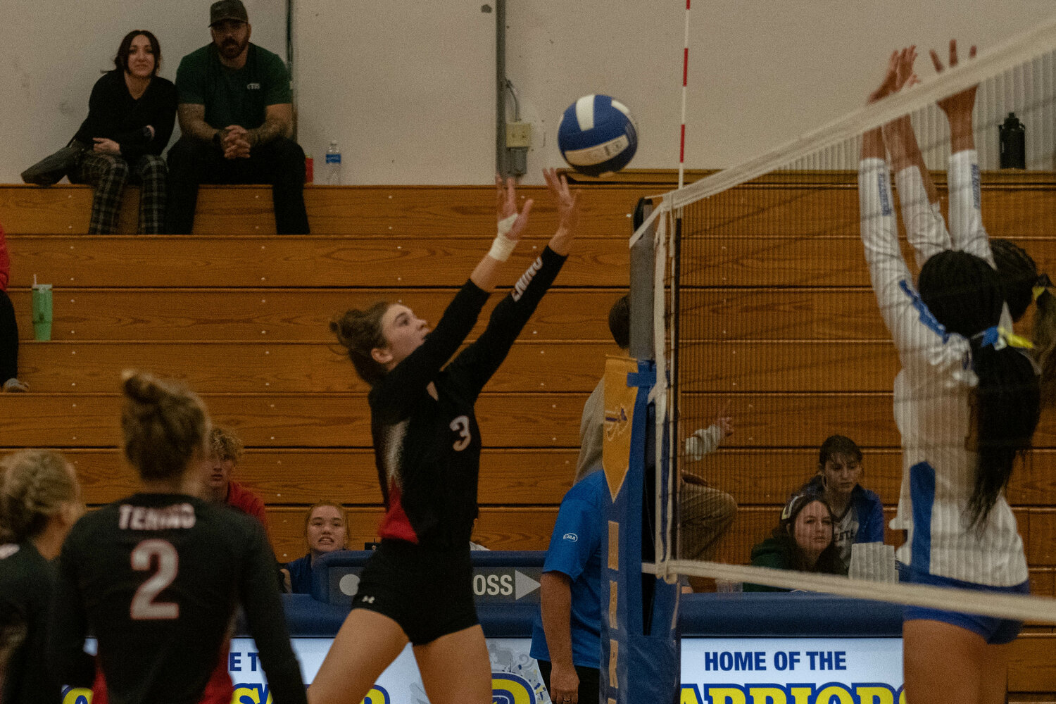 Brooke Bratton tips the ball over the net during Tenino's three-set win at Rochester on Sept. 18.