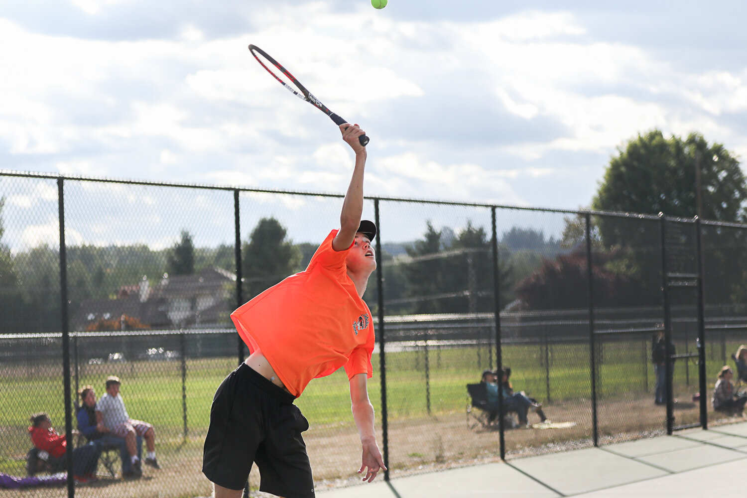 Jacoby Corwin goes up for a serve during his match against Tumwater on Sept. 20.