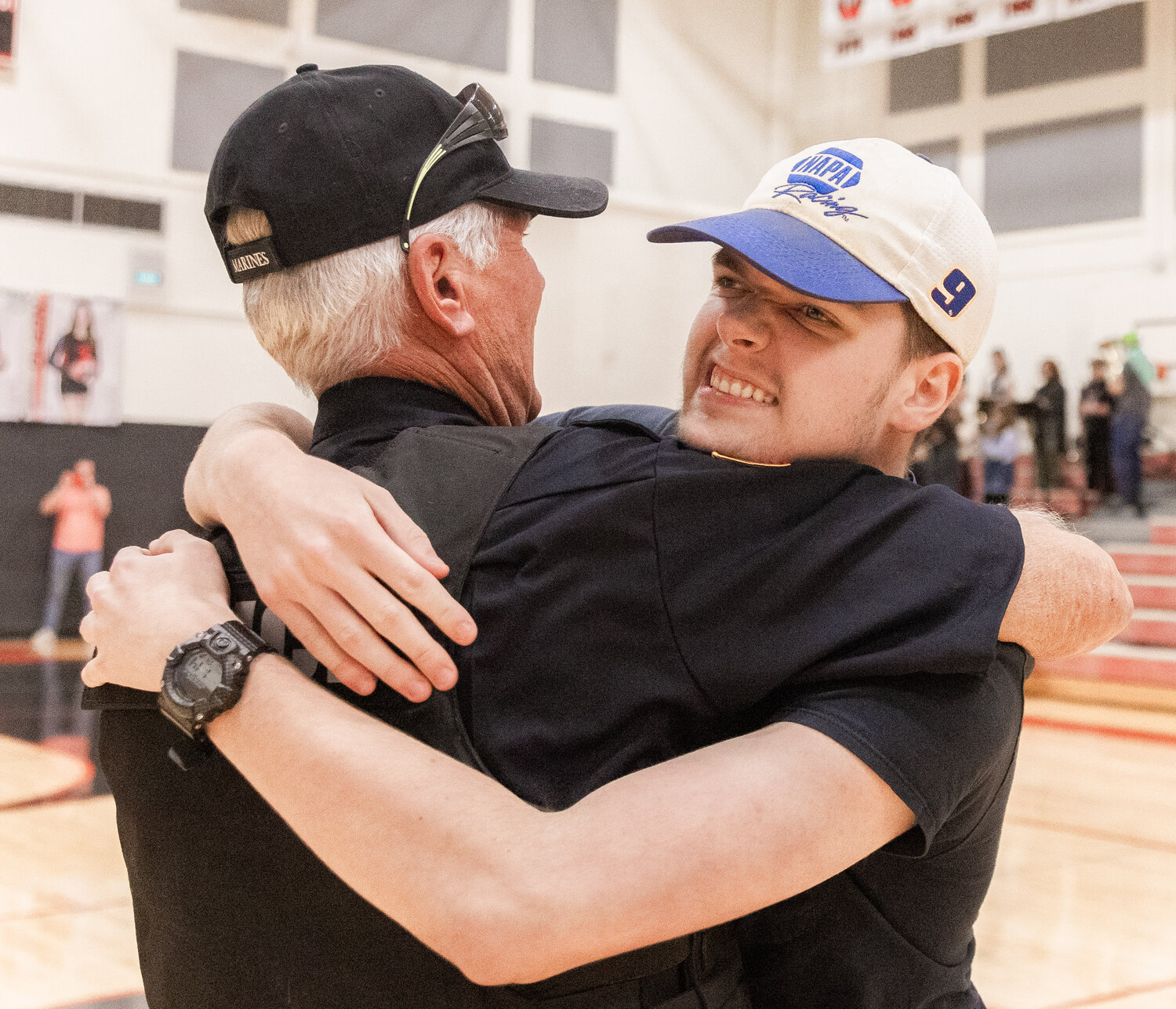 Chris Harvey receives an embrace after sinking a shot to mark 2,000 made half-court buckets at Toledo High School on Thursday, Sept. 21.