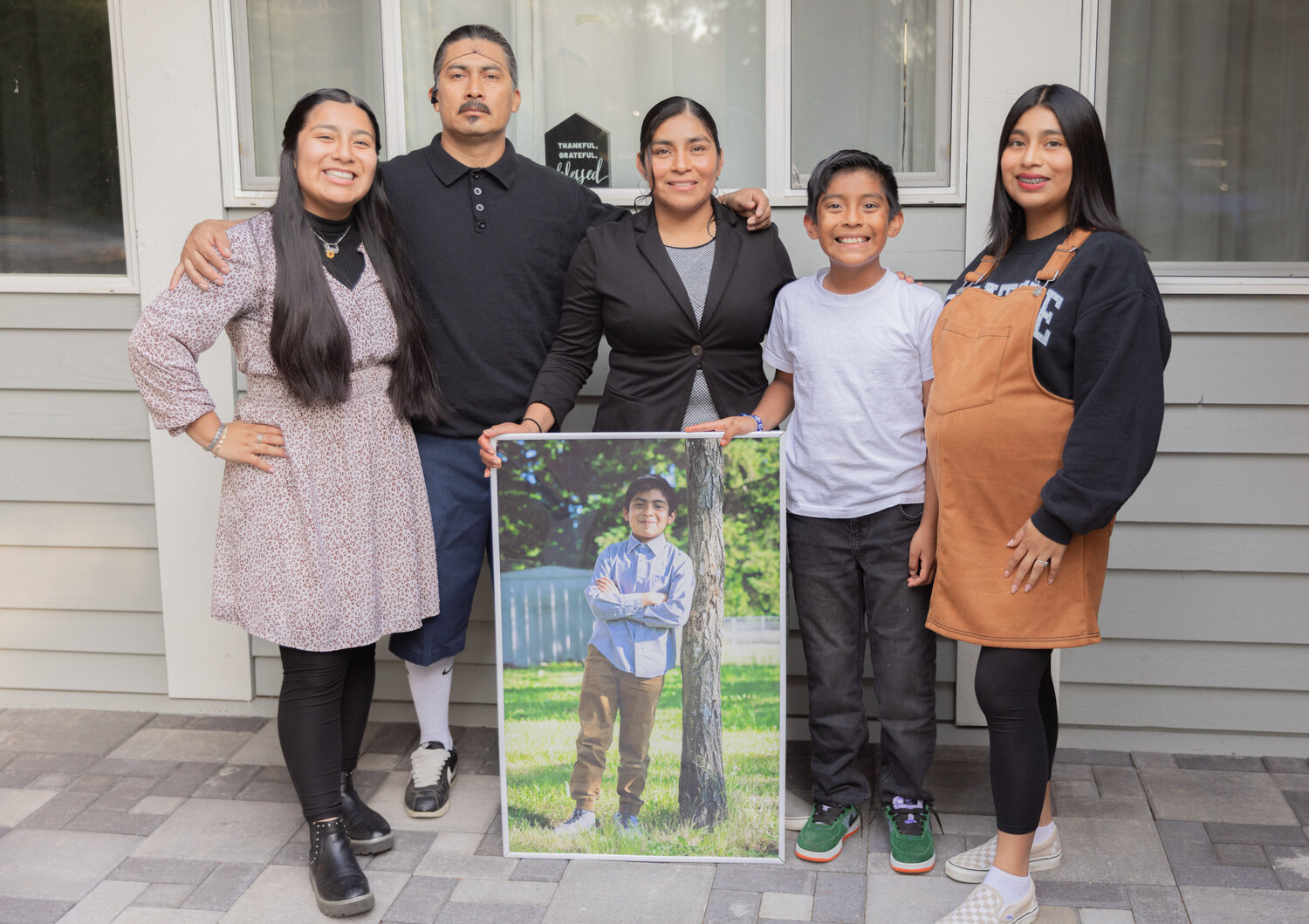 The Flores family from left, Daisey, Isaias, Yolanda, Isai, Isaac and Nicole smile for a photo at their Centralia residence on Thursday, Sept. 21.