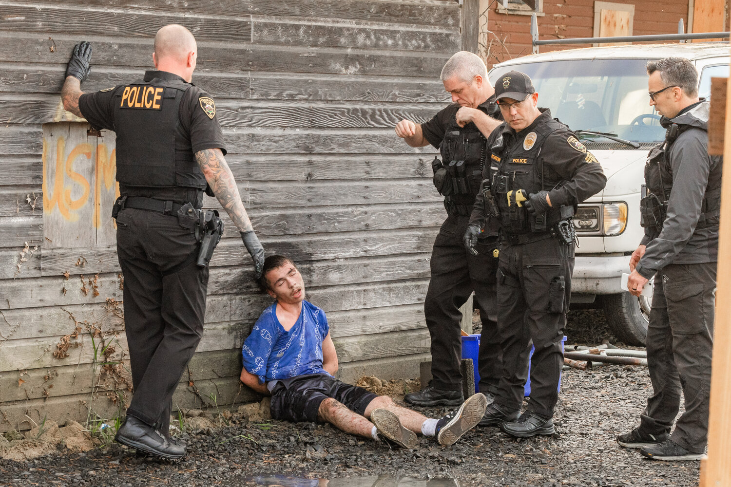 Dayton L. Keyes sits with handcuffs on after leading officers on a foot pursuit in Centralia on Monday, Oct. 16.
