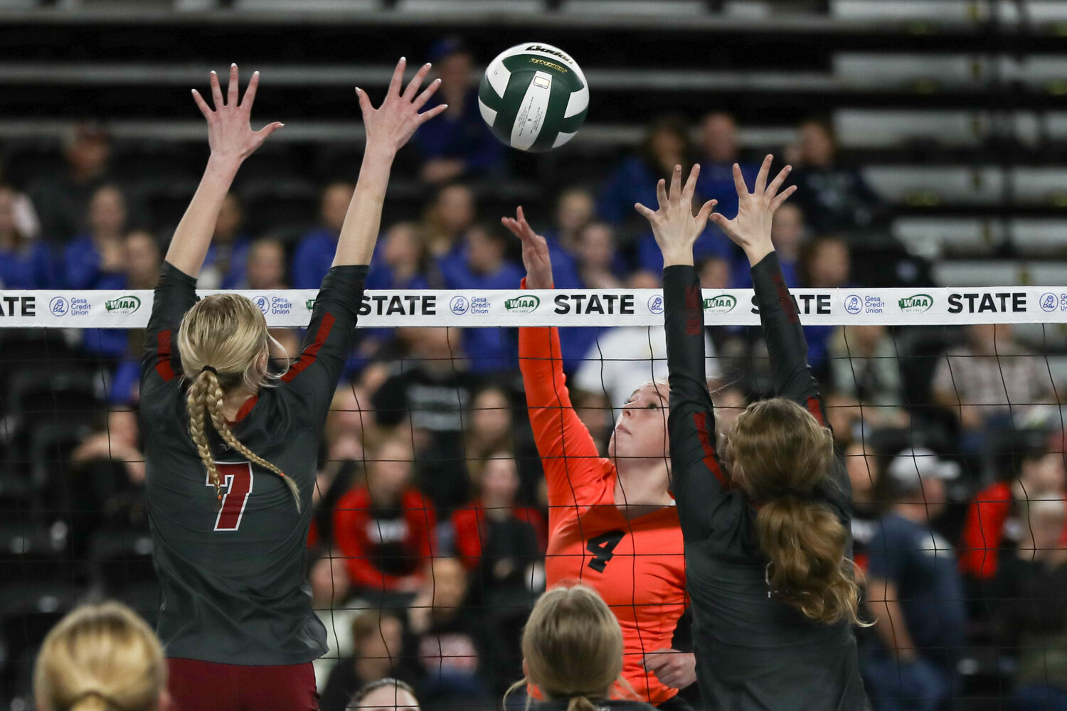 Grace Gall tips the ball over two Okanogan defenders during Napavine's first-round matchup at the state tournament on Nov. 8 in Yakima.