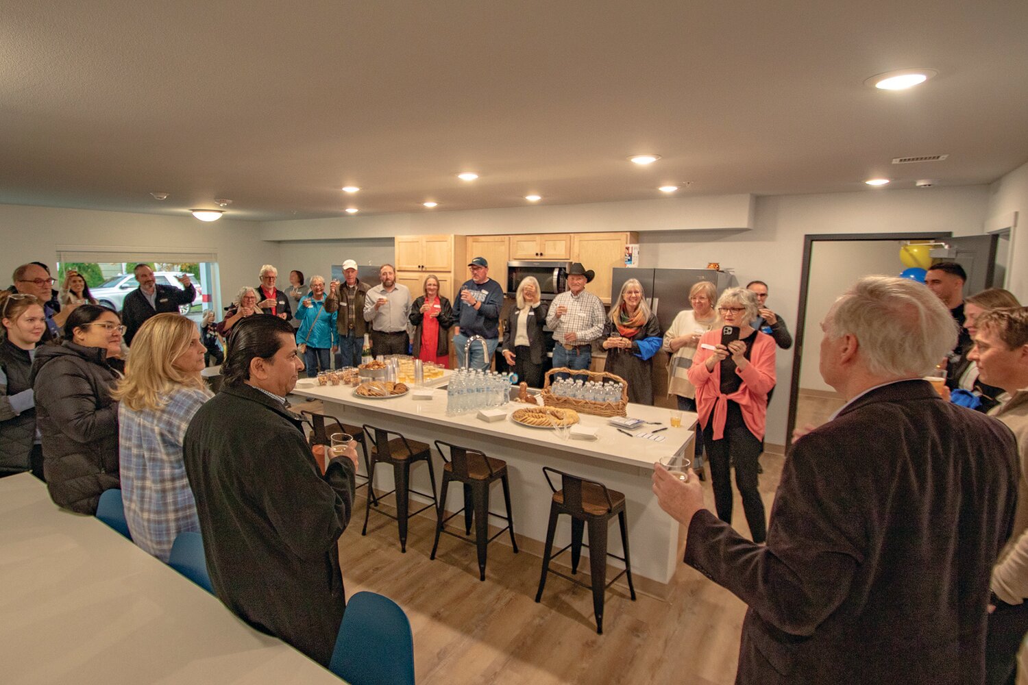 CHI managing member Joel Crosby leads open house attendees in a toast celebring the completion of the new apartment complex for Centralia College students on Tuesday, Nov. 7.