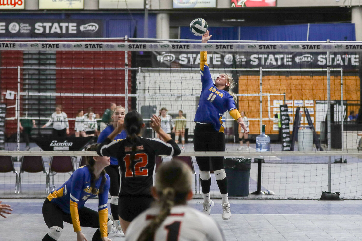 Kendall Humphrey bats the ball over the net during Adna's match with Rainier in the state quarterfinals on Nov. 8 in Yakima.