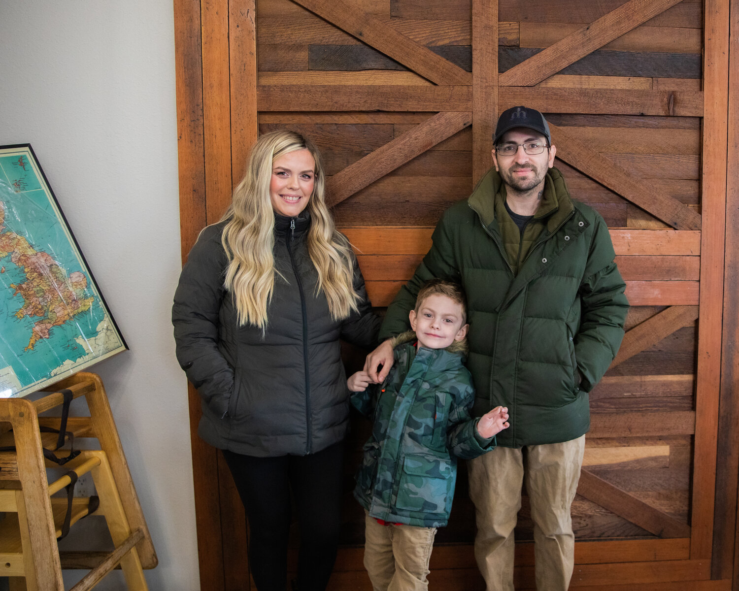 Lori and Mike West pose for a photo alongside son Morgan at the location of British Bites in Centralia as the building was remodeled last October.