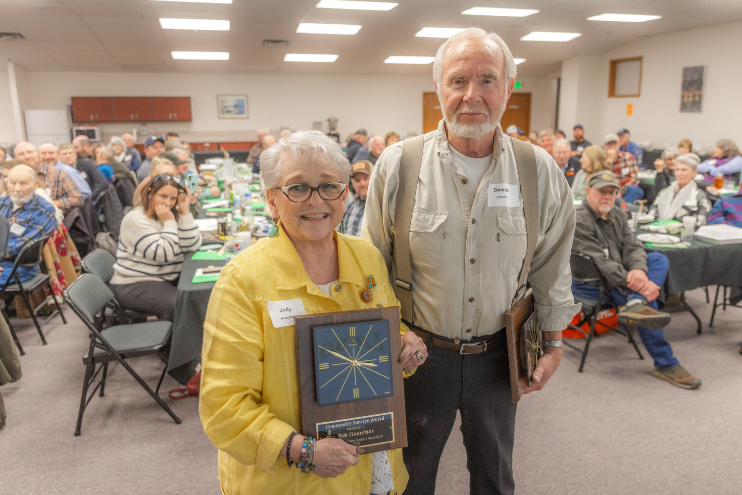 Judy Guenther and Dennis Larson pose for a photo with their awards during the Lewis County Farm Forestry Association awards banquet in Chehalis on Tuesday, Nov. 14.