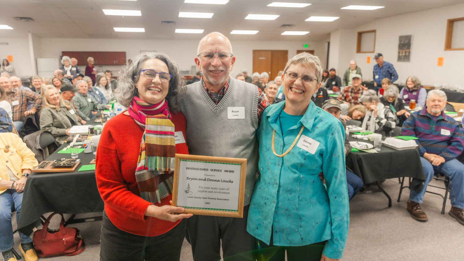 Byron, center, and Donna Loucks, far right, are presented the Distinguished Service Award during the Lewis County Farm Forestry Association awards banquet in Chehalis on Tuesday, Nov. 14.
