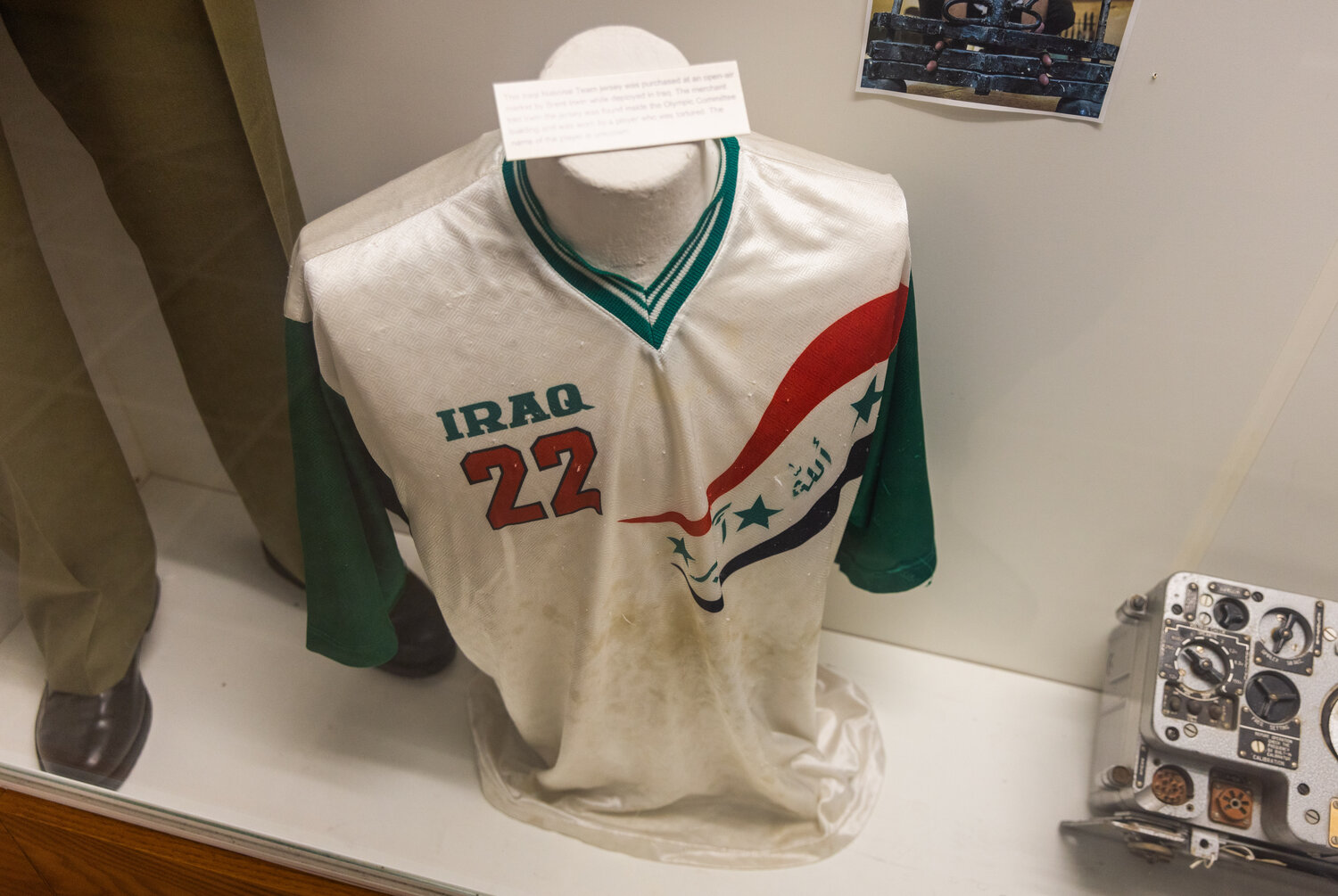 An authenticated outfit tailored for Saddam Hussein sits on display alongside a blood protein stained Iraq soccer jersey at the Veterans Memorial Museum in Chehalis on Tuesday, Nov. 14. Uday Hussein, the eldest son of Iraq’s President, directed punishments and torture for athletes after losing games. Iraq had the only Olympic headquarters in the world equipped with its own prison.