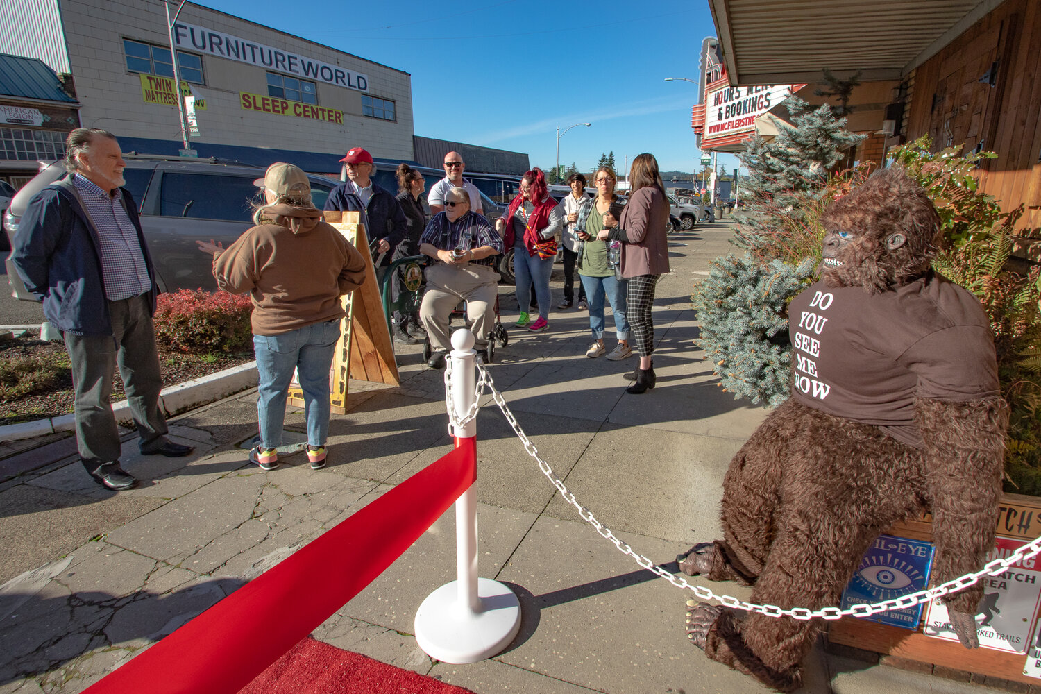 Chehalis City Councilors and residents gather outside Bigfoot Treasure in downtown Chehalis for its ribbon cutting ceremony on Tuesday, Nov. 14.