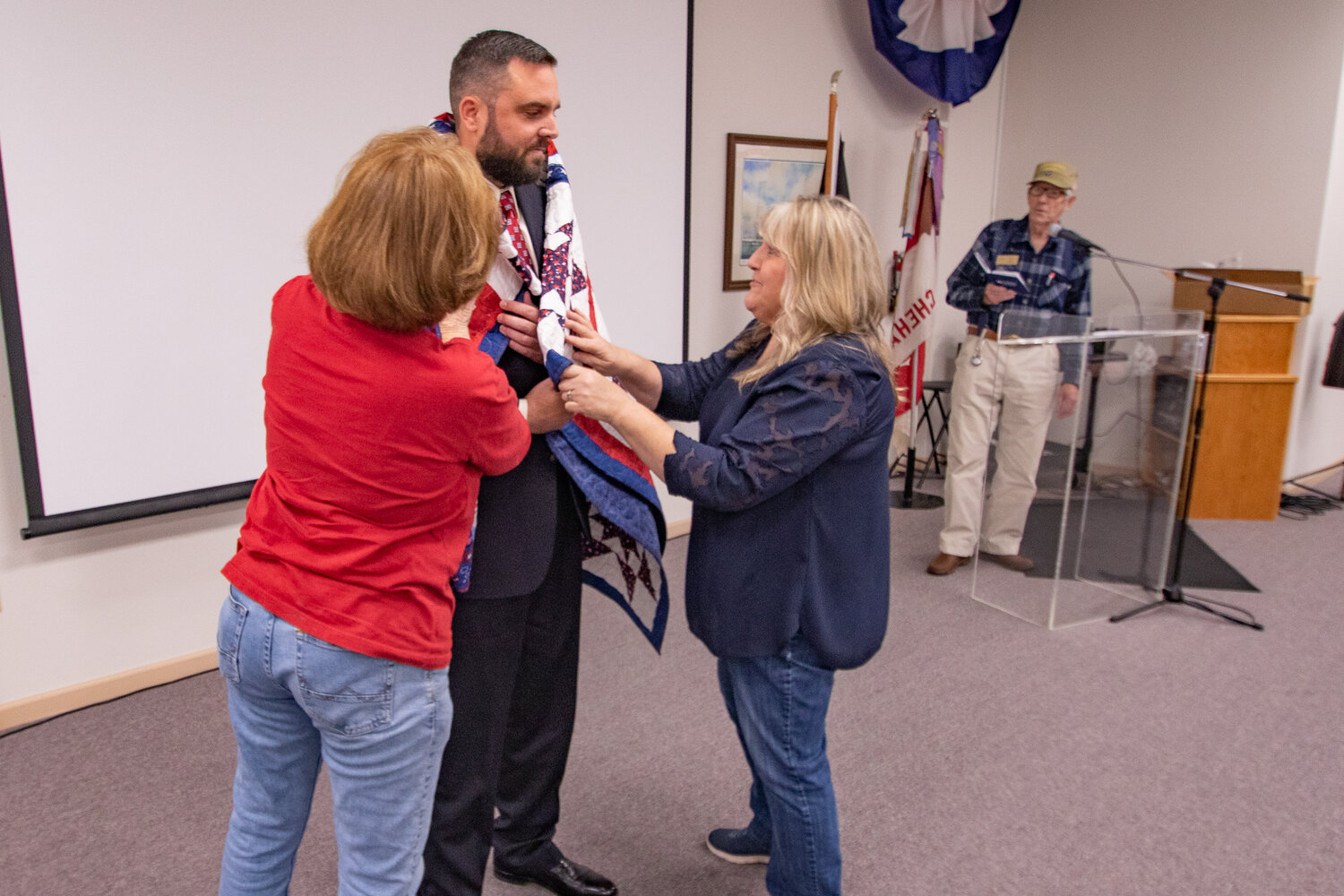 Ryan Foreman, a U.S. Army veteran and Bronze Star recipient, receives a quilt from Veterans Memorial Museum Quilts of Valor chapter members on Saturday, Nov. 11.