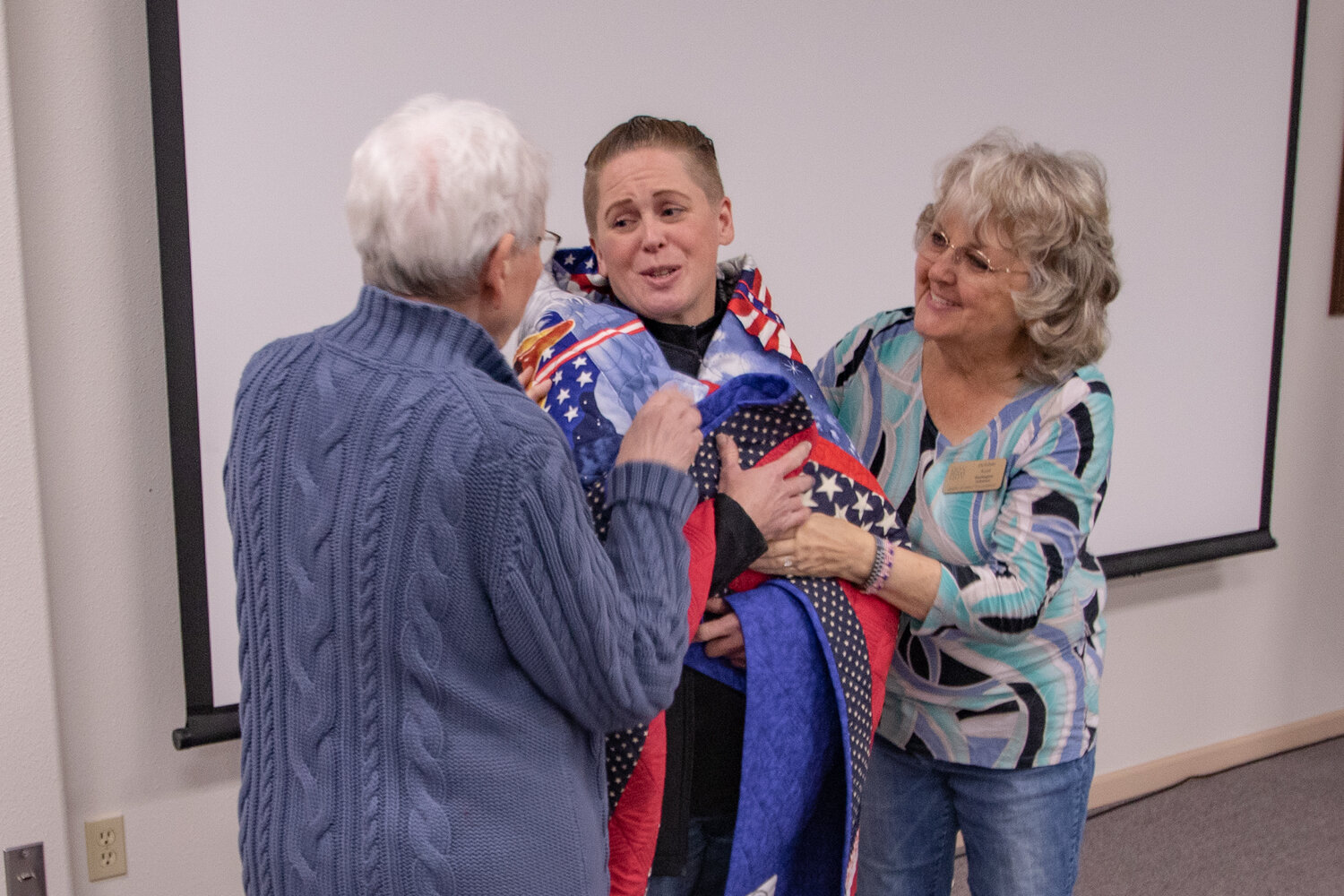 U.S. Army veteran Tabitha Hopp thanks Veterans Memorial Museum Quilts of Valor chapter members after receiving her quilt on Saturday, Nov. 11.