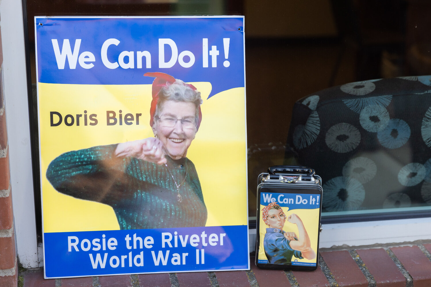 A poster of Doris Bier posed in “Rosie The Riveter,” fashion sits on display in Chehalis outside the Lewis County Public Utility District building on Thursday.