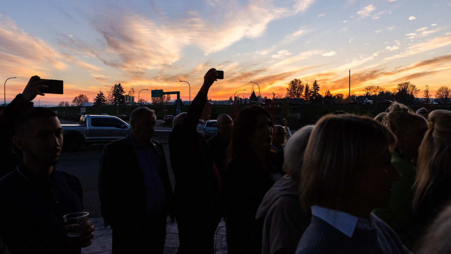 Attendees gather and watch a ribbon cutting ceremony for La Quinta by Wyndham in Centralia as the sun set Wednesday, Nov. 15.