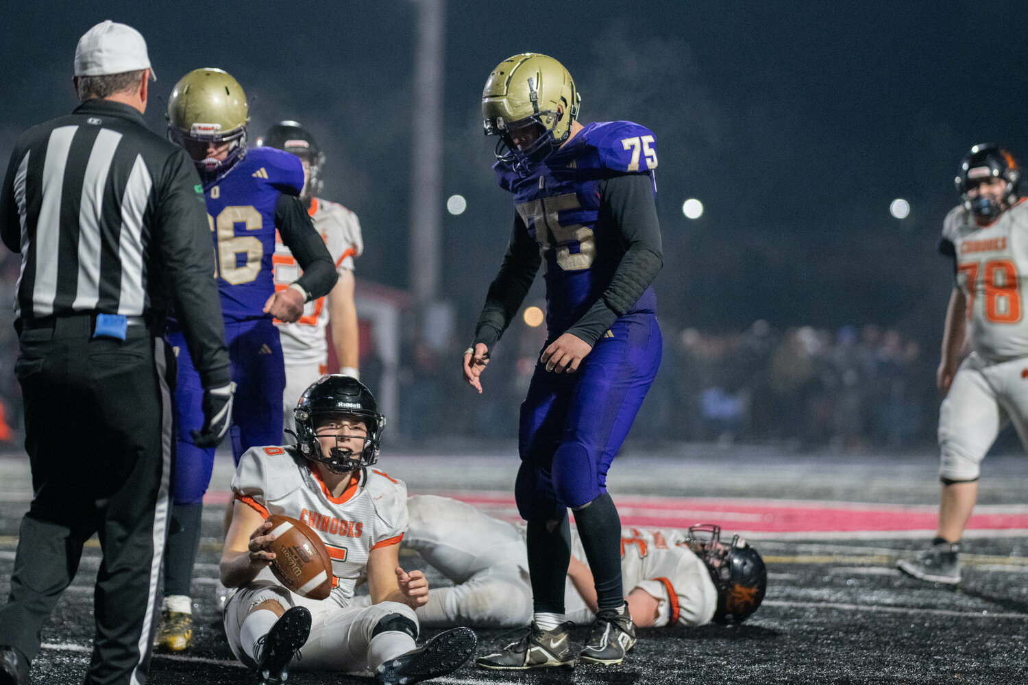 Rylan McGraw stands over Kalama quarterback Aiden Brown after a foirth-down stop in the second half of Onalaska's 60-40 win over the Chinooks in the 2B quarterfinals, Nov. 17 in Tenino.