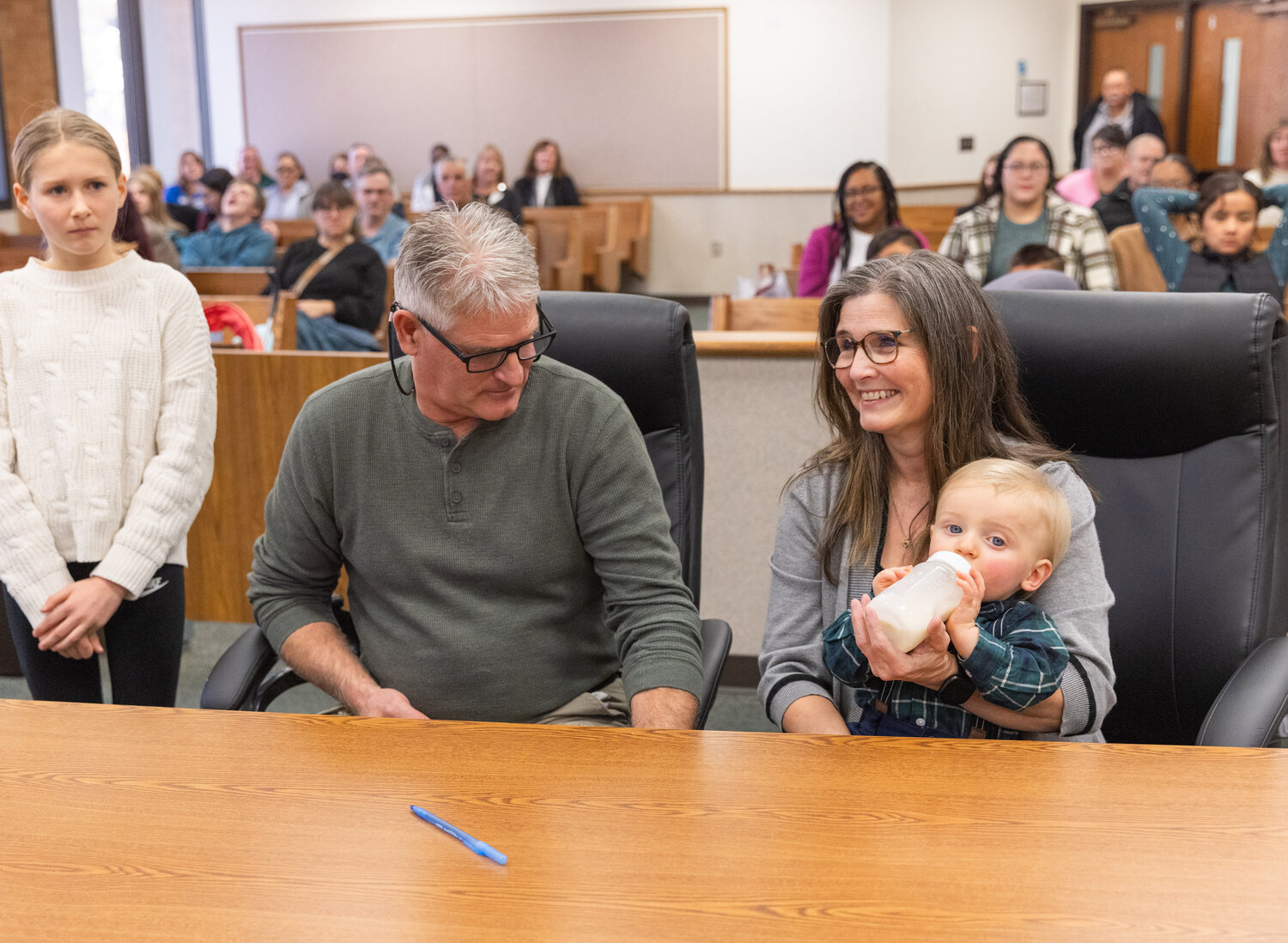 Rachel and William Harris smile with their kids on National Adoption Day in Lewis County Superior Court Friday afternoon in Chehalis.