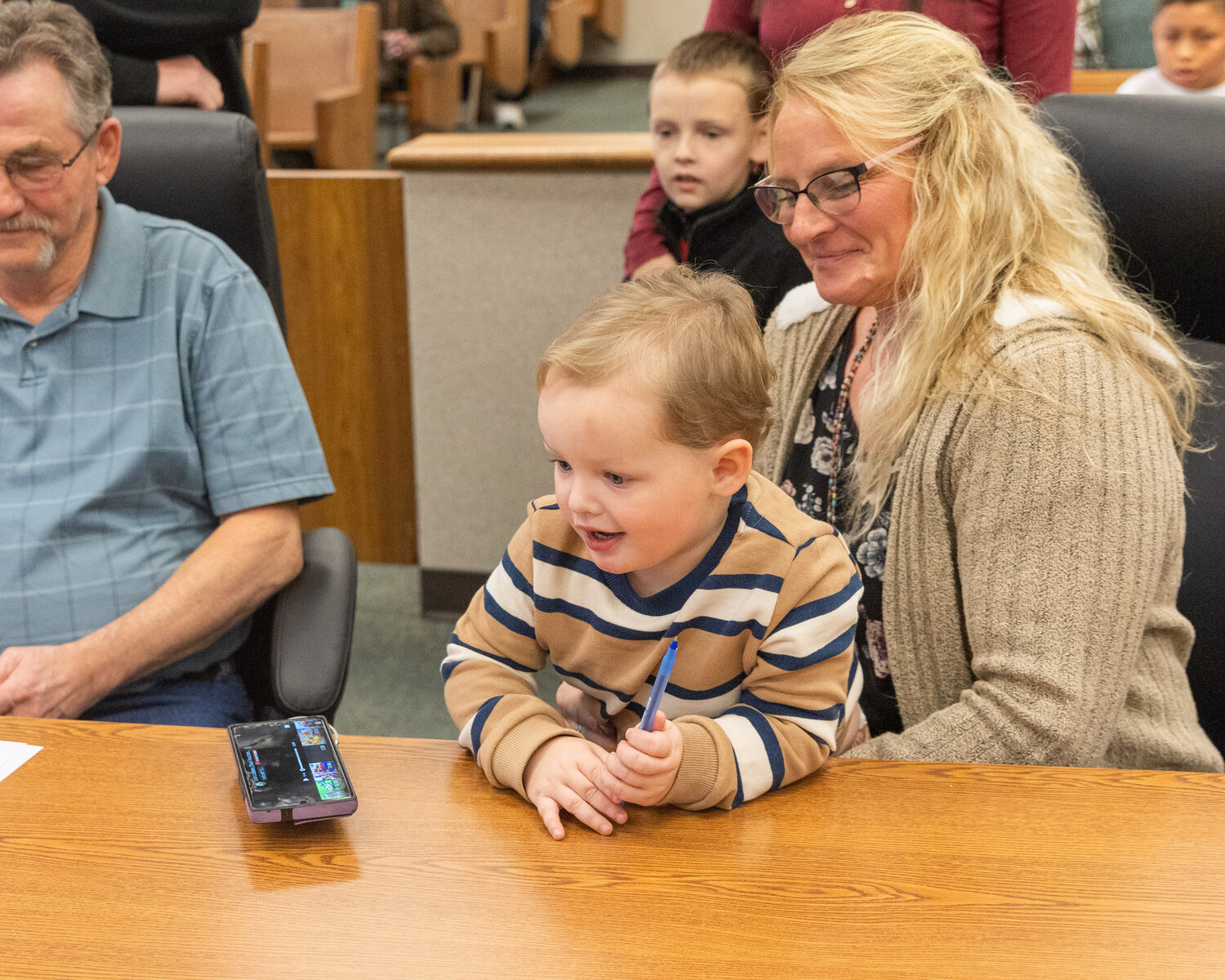 William and Stacy Burleson prepare to sign adoption paperwork on Friday in Chehalis.