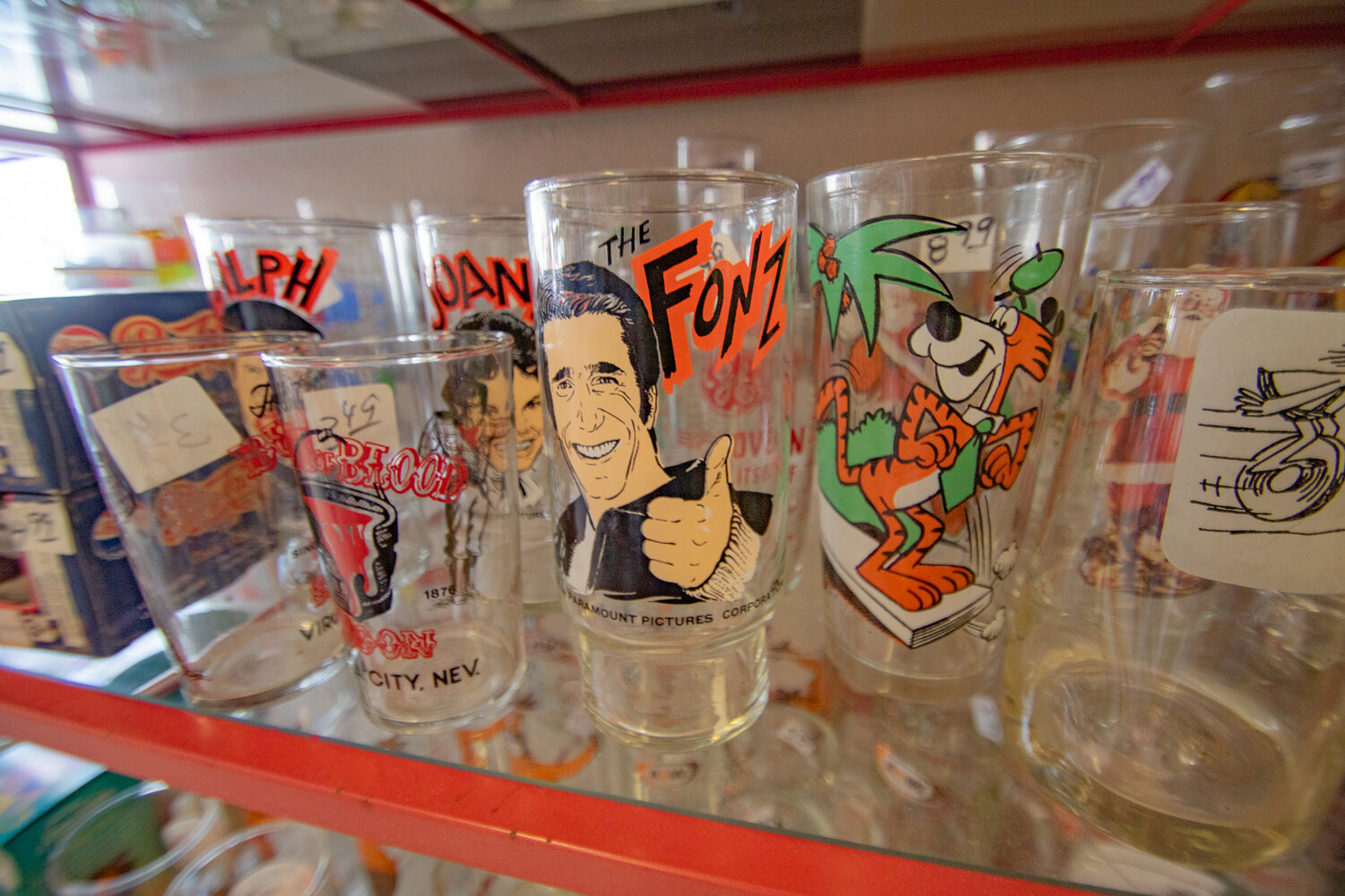 Collectible glass cups fill the shelves at Community Thrift in Centralia on Tuesday, Nov. 7.