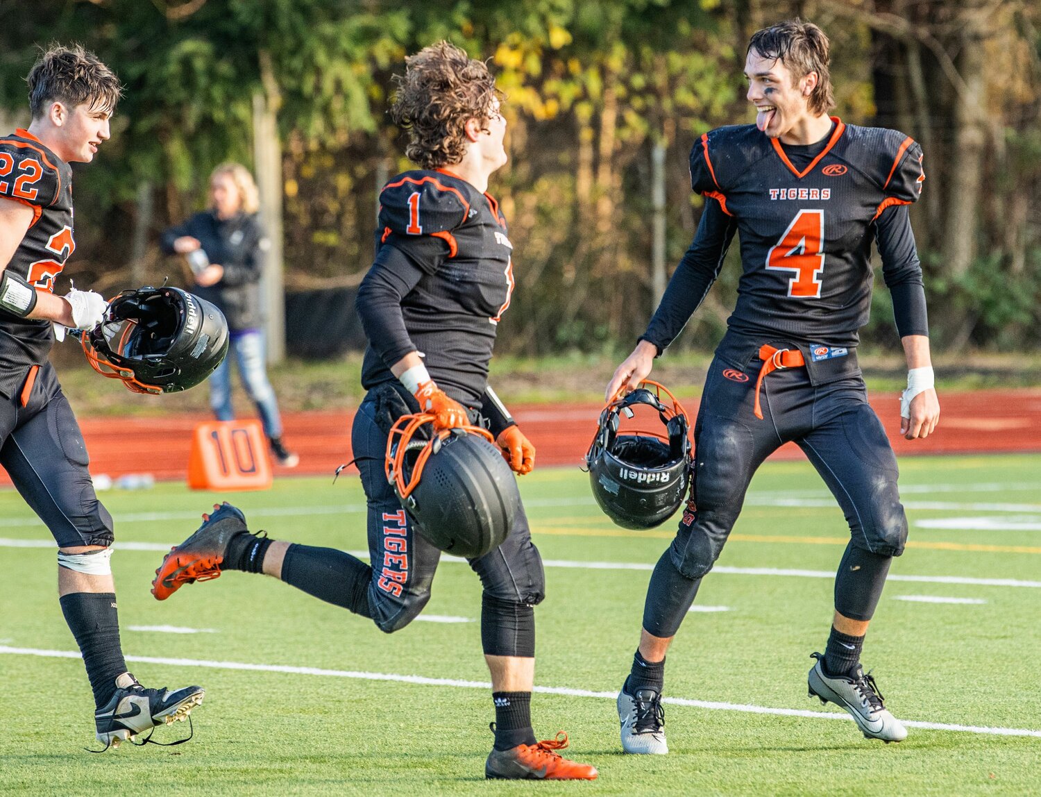 Quarterback Ashton Demarest looks toward his teammates while sticking his tongue out after the Napavine Tigers topped the Onalaska Loggers in Tumwater on Saturday at the 2B state semifinals.
