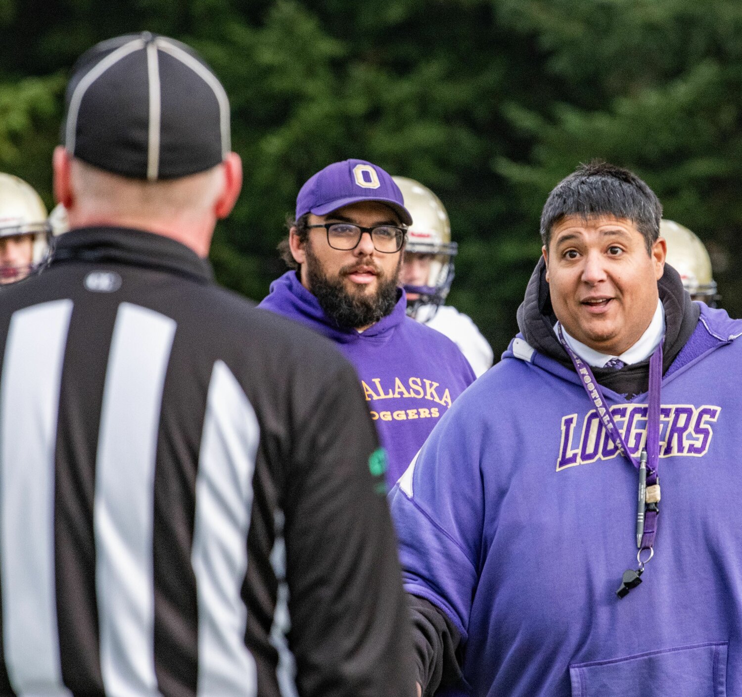 Onalaska coach Mazen Saade talks to a referee while walking off the field for halftime in the state 2B semifinals against Napavine on Saturday in Tumwater.