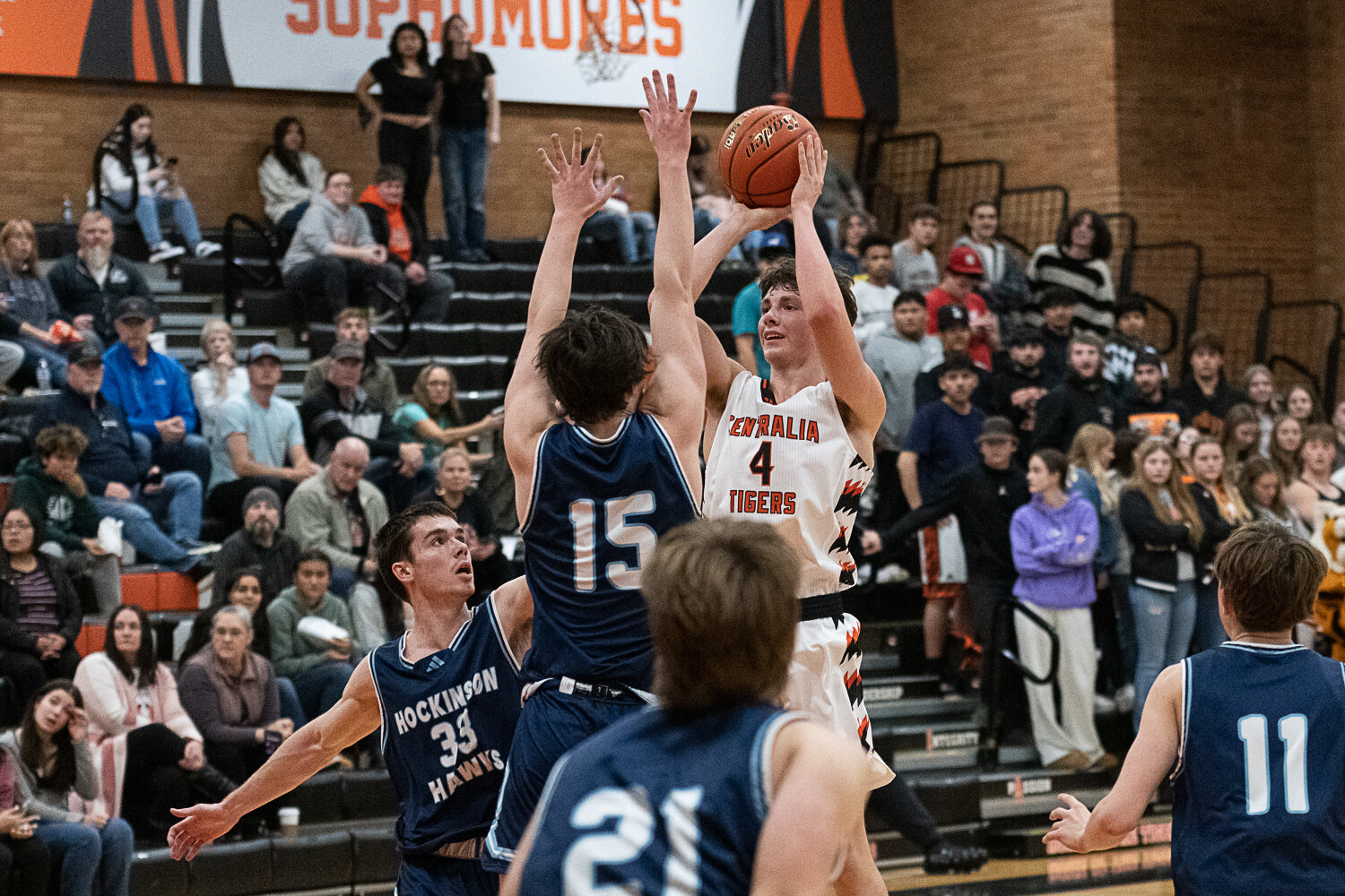 Aidan Haines shoots over multiple defenders during Centralia's loss against Hockinson on Nov. 27.