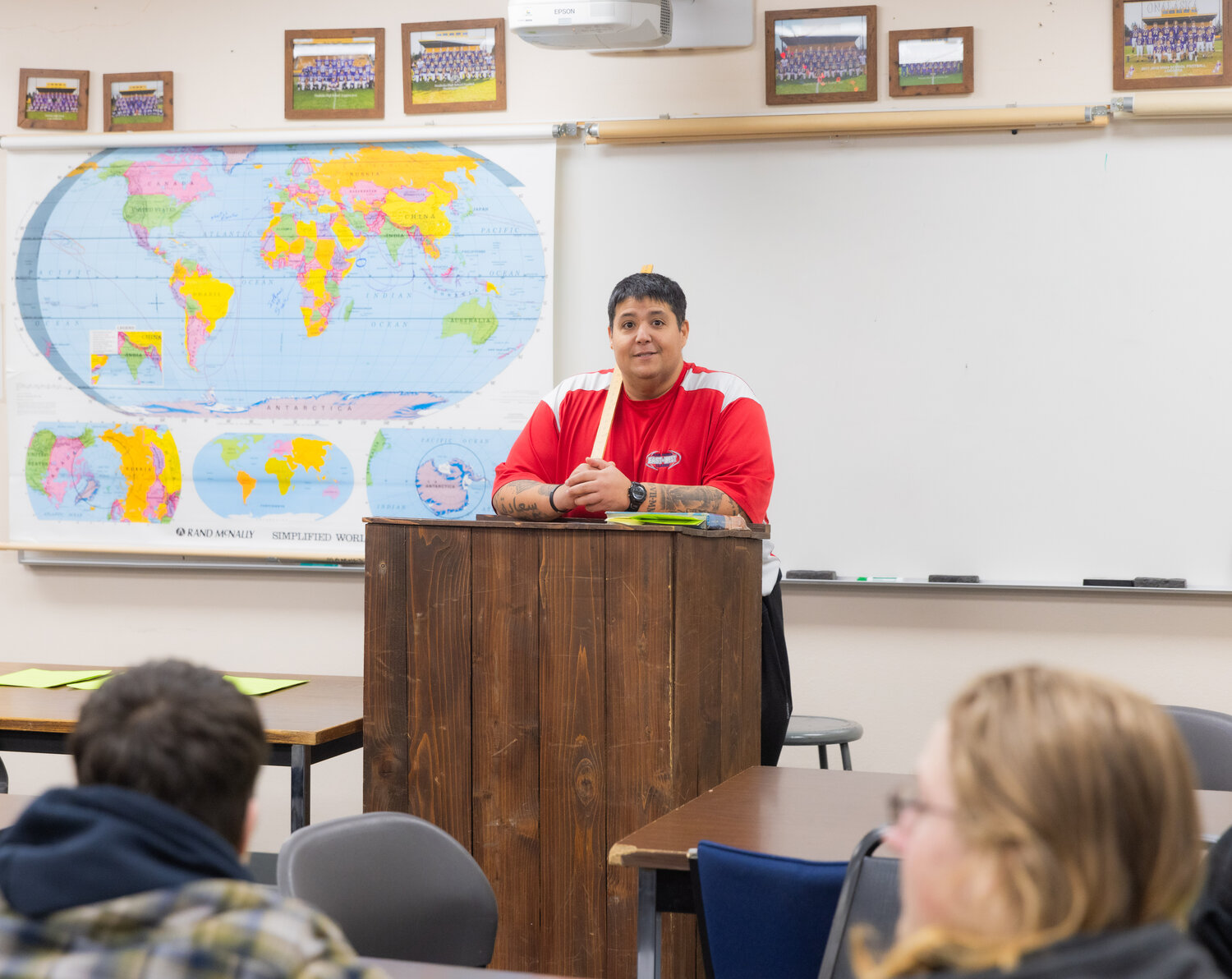 Mazen Saade, a history teacher, smiles while educating students from a podium at Onalaska High School on Tuesday, Nov. 28.