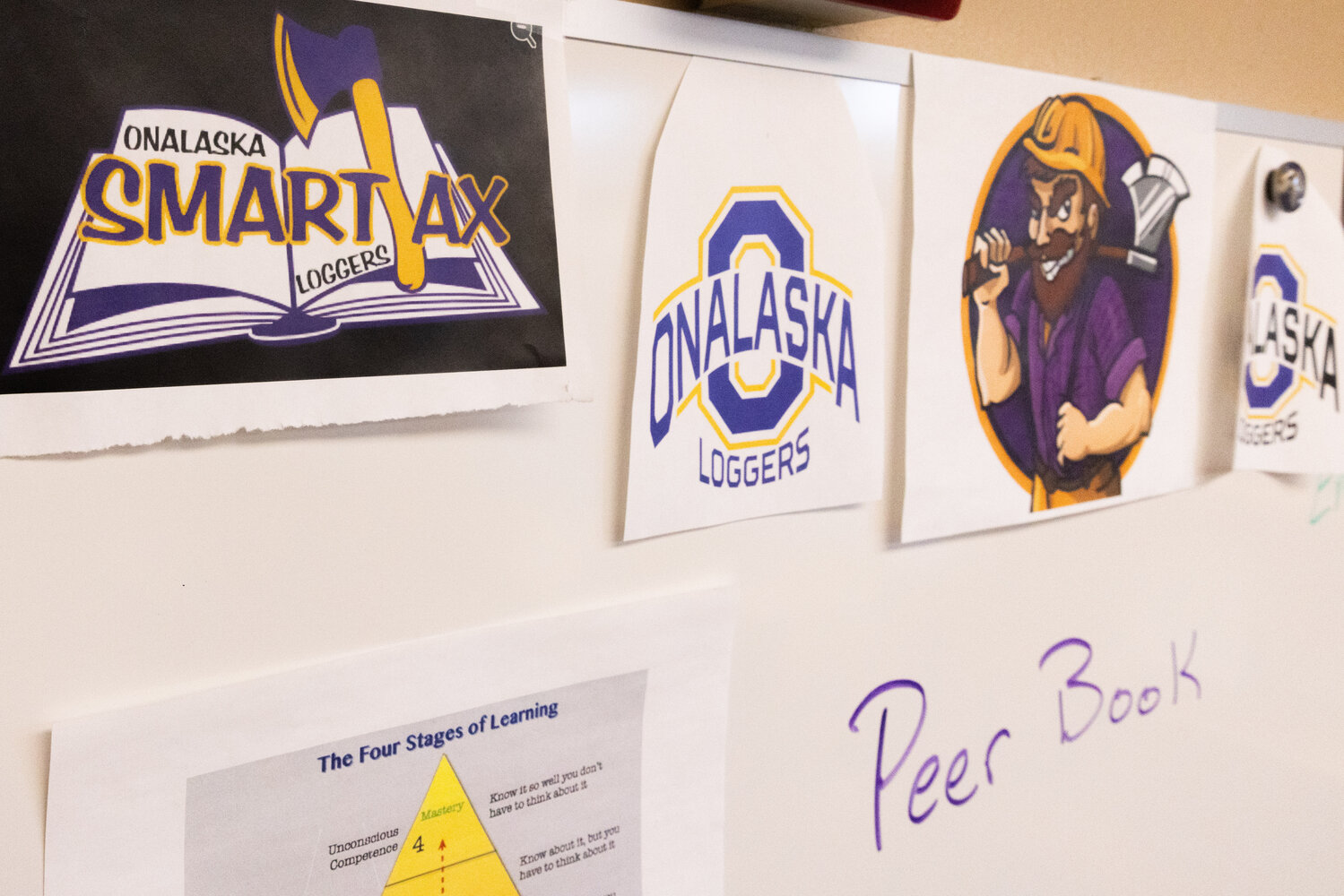 Logos designed by parents and staff hang on display at Onalaska High School on Tuesday, Nov. 28.