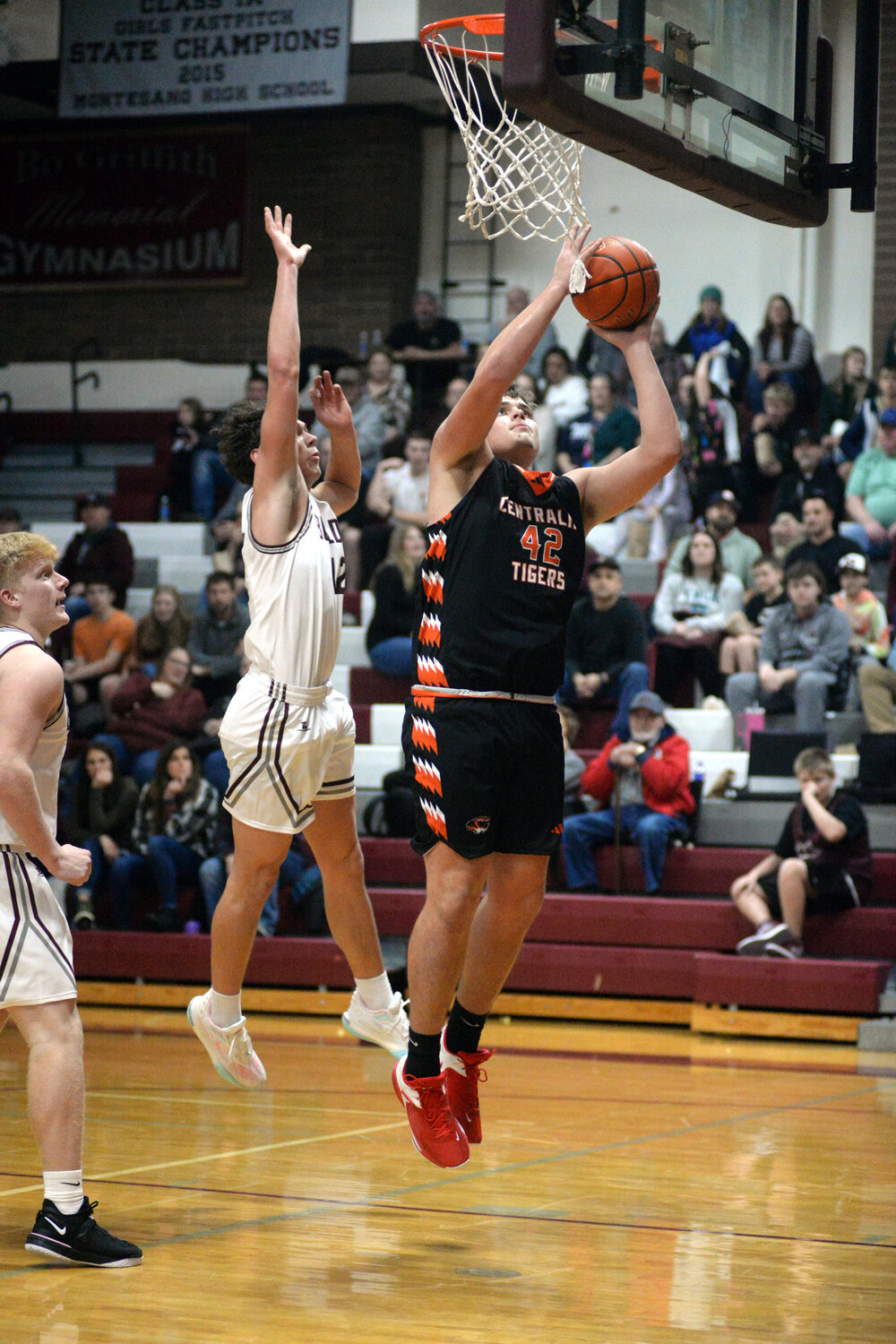 Centralia center David Daarud (42) scores against Montesano's Gabe Bodwell during the second half of the Tigers' 69-43 loss on Tuesday in Montesano.