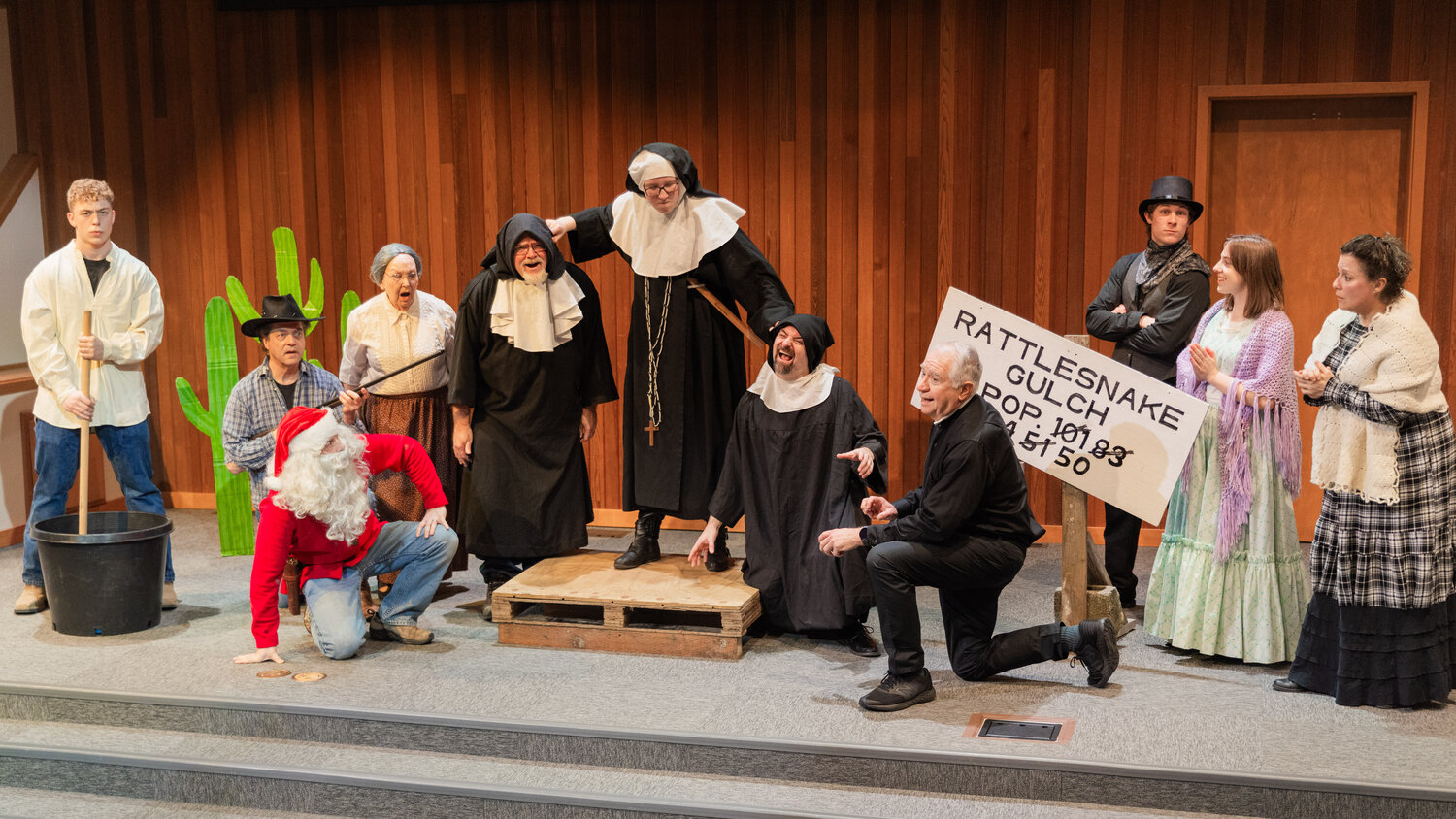 From left, Joseph Caserta as Big Hank, Dale Bradrick as Roscoe, Kevin Caserta as Old Frank, Kay Morton as Louise Binder, Randy Humphreys as Hector Bogonzoles, Gloria Wilcox as Sister Perpetua, Alex Johnson as Jake Headley, Mark Johnson as Reverend Fred Binder, Sam Mittge as Mayor Thomas Percifield, Elise Caserta as Hildegard Percifield and Neli VonWald as Jane Binder perform on stage during dress rehearsals for the Christmas at Rattlesnake Gulch play at Mountain View Baptist Church in Centralia.