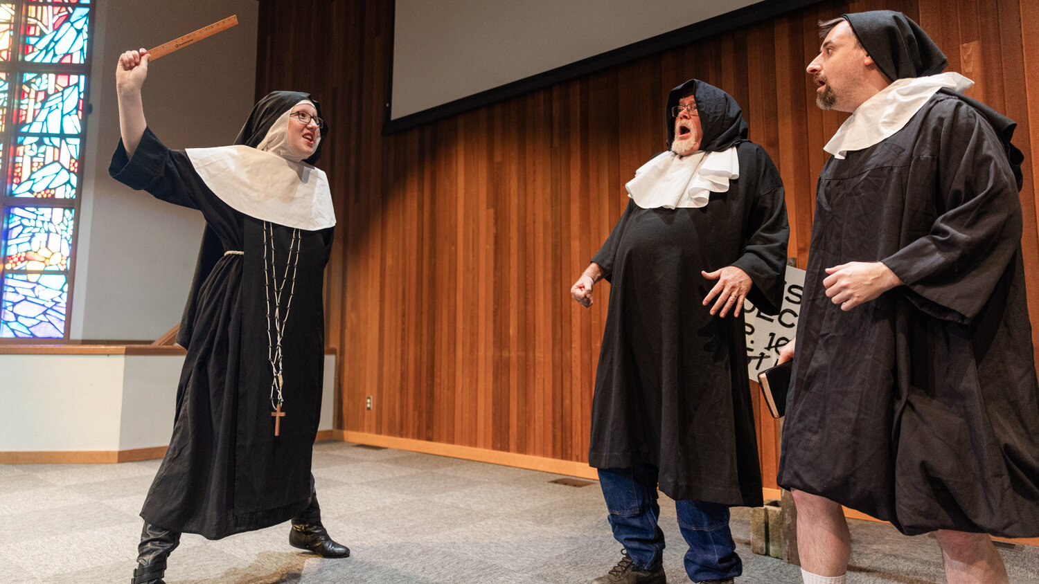 Gloria Wilcox as Sister Perpetua yells at Randy Humphreys as Hector Bogonzoles and Alex Johnson as Jake Headley as they perform on stage during dress rehearsals for the Christmas at Rattlesnake Gulch play at Mountain View Baptist Church in Centralia.
