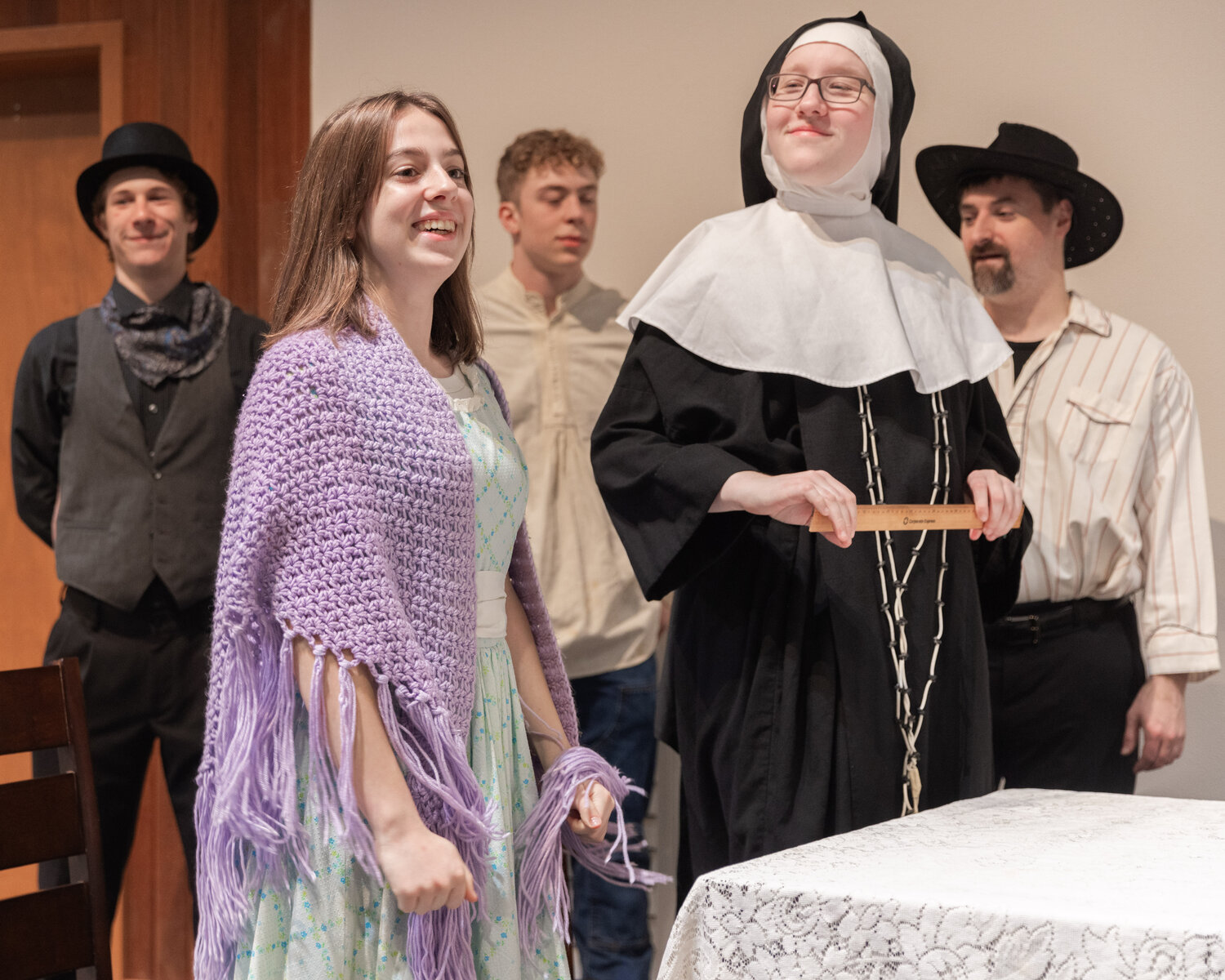 Elise Caserta as Hildegard Percifield, center left, smiles on stage during dress rehearsals for the Christmas at Rattlesnake Gulch play at Mountain View Baptist Church in Centralia.