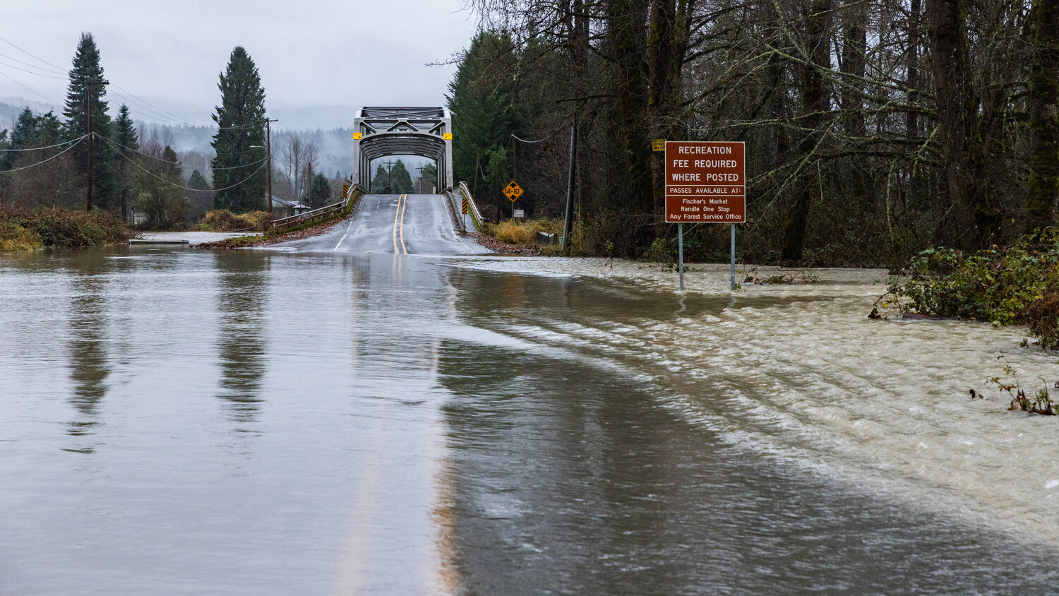 Water from the Cowlitz River spills over state Route 131 in Randle on Wednesday, Dec. 6.