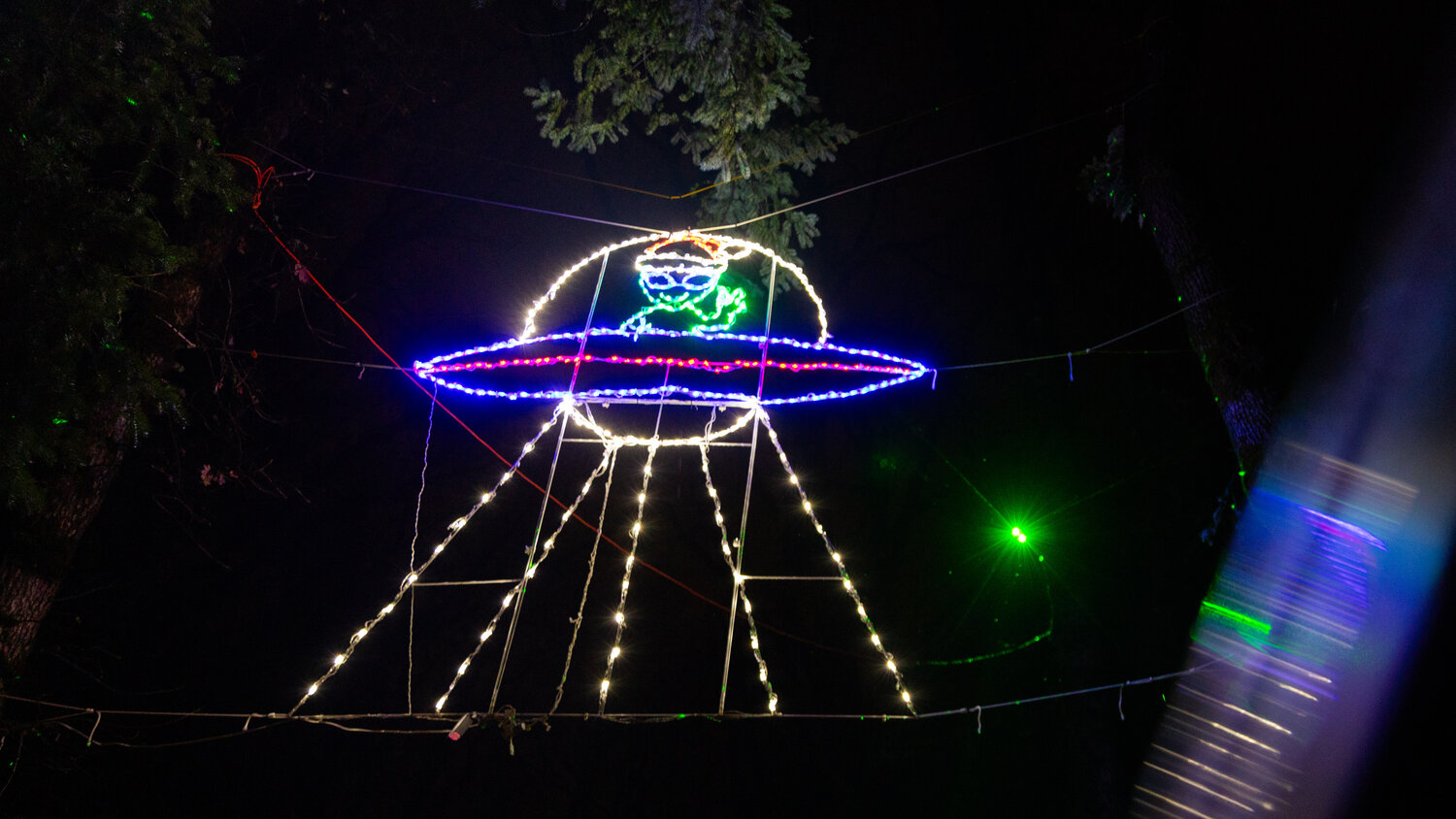 Illuminated lights depict an alien with a Santa hat flying high above Borst Park in Centralia on Thursday, Dec. 7.