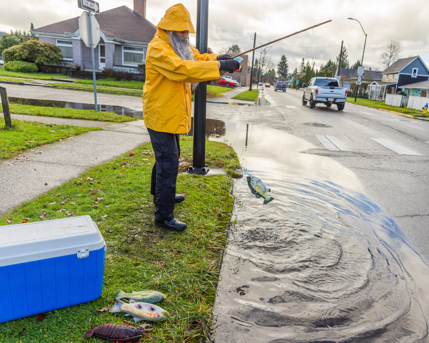 Henry Wegener hooks a plastic fish along South Pearl Street in Centralia as water levels begin to drop around Hub City on Thursday, Dec. 7.