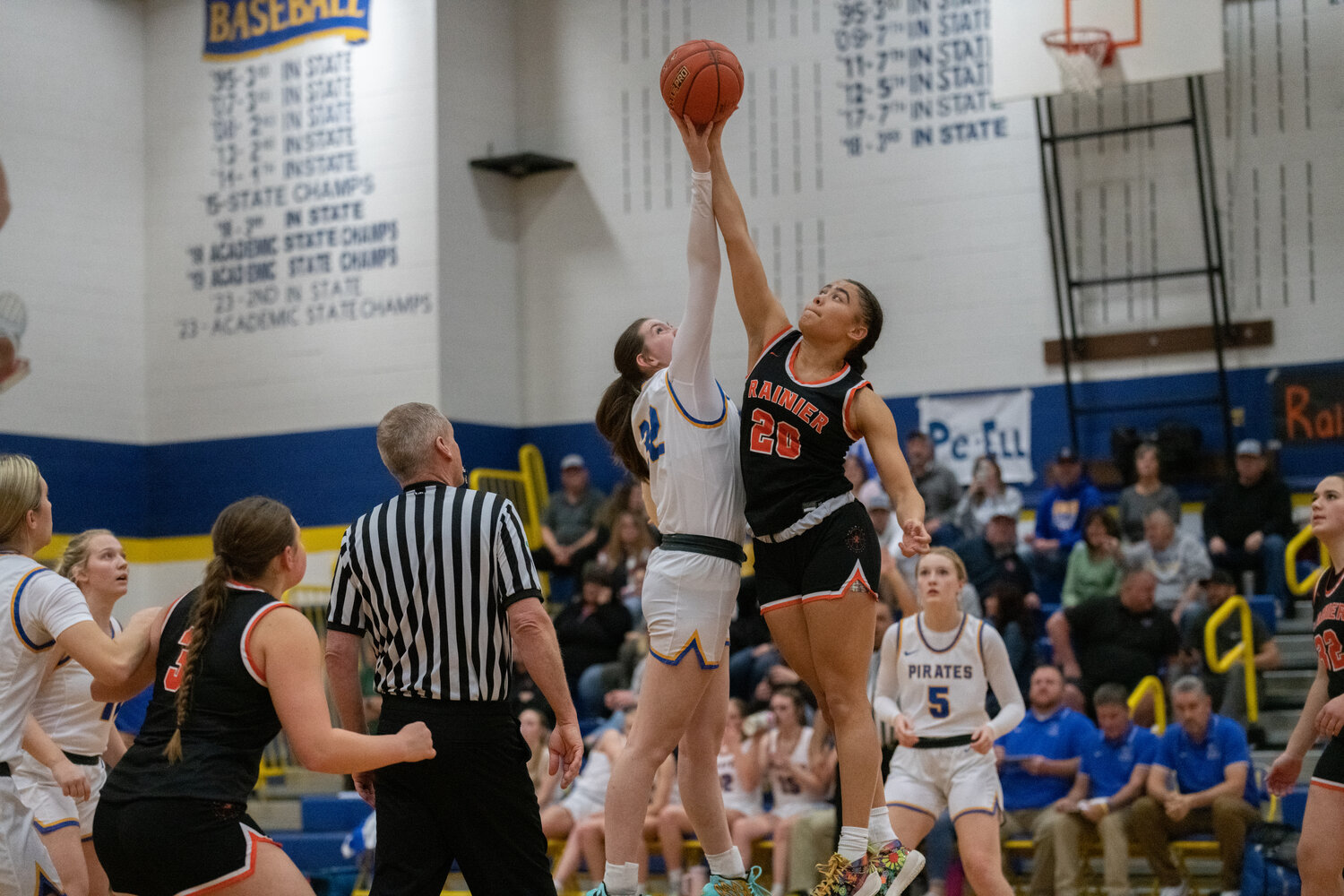 Adna's Bailey Chapman and Rainier's Janess Blackburn jump for the opening tip during the Pirates' matchup against the Mountaineers, Dec. 8 in Adna.