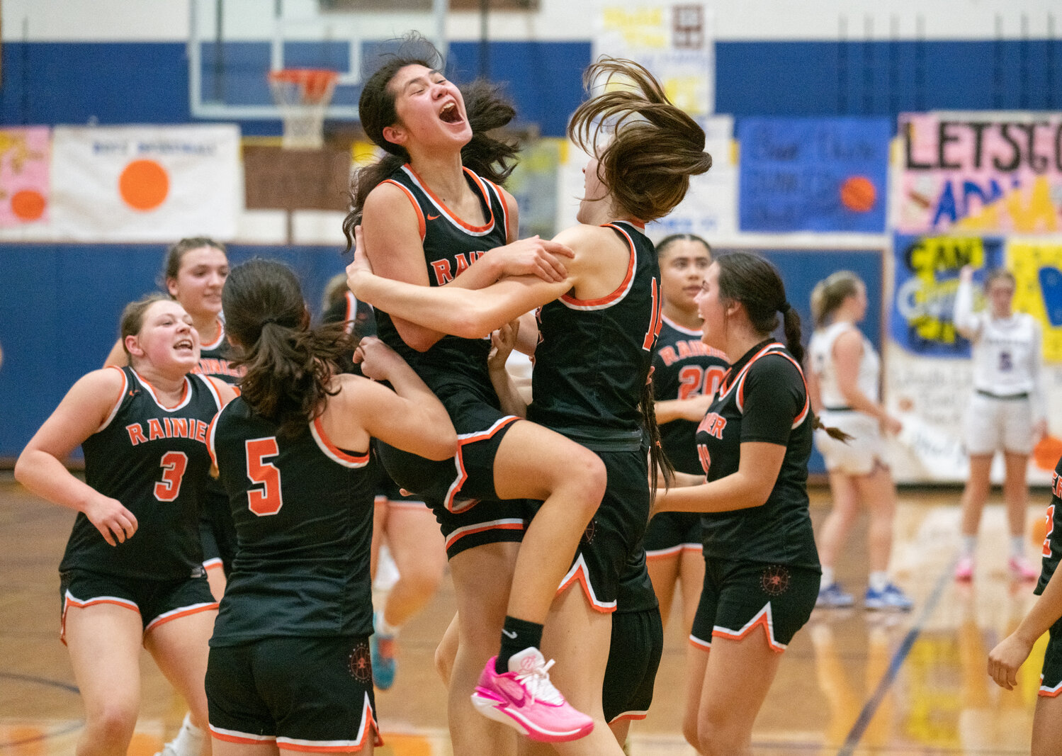 Angelica Askey and the Rainier Mountaineers celebrate their 52-49 win at Adna on Dec. 8.