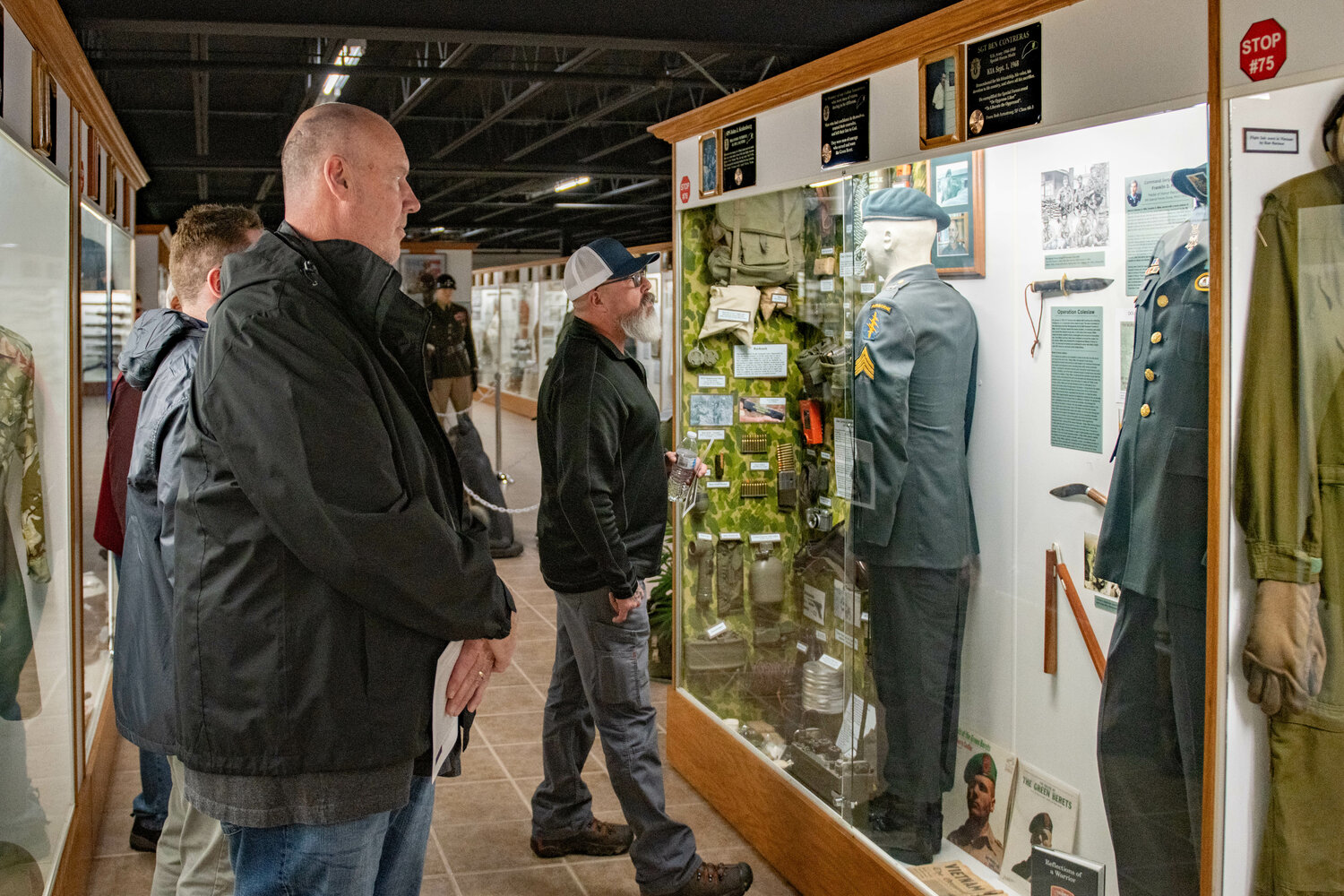 Attendees observe a display honoring Medal of honor recipient Franklin D. Miller after a ceremony at the Veterans Memorial Museum in Chehalis on Jan. 5.
